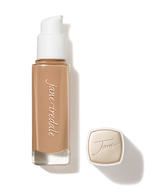 Jane Iredale Skintuition SPF 30 Radiance-Boosting Liquid Foundation in warm beige with pump cap, offering medium-to-full coverage and skincare benefits.