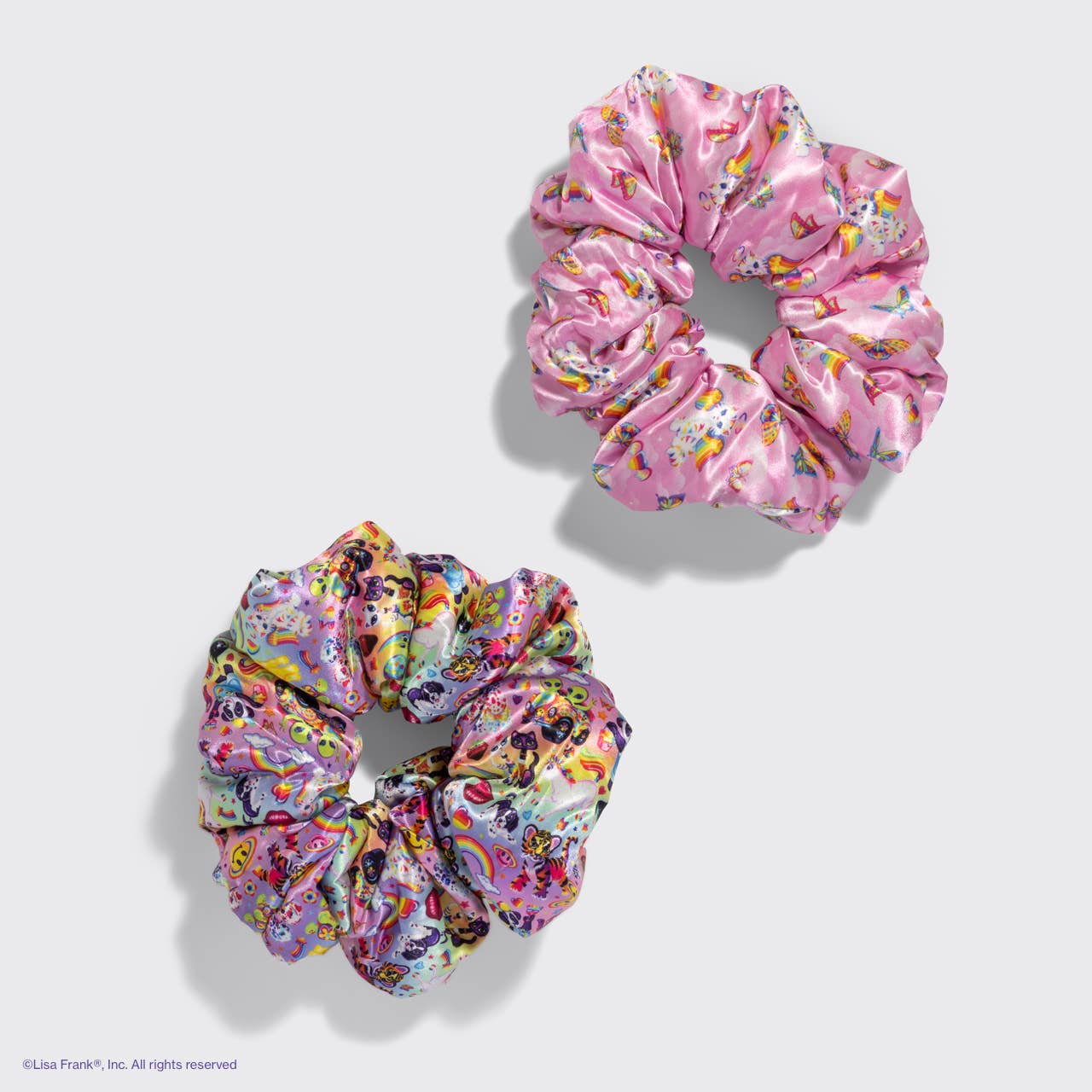 Lisa Frank x Kitsch Pillow Scrunchies® in Satin feature whimsical motifs on glossy fabric, offering a gentle, snag-free hold with pillow-soft comfort for all hair types.