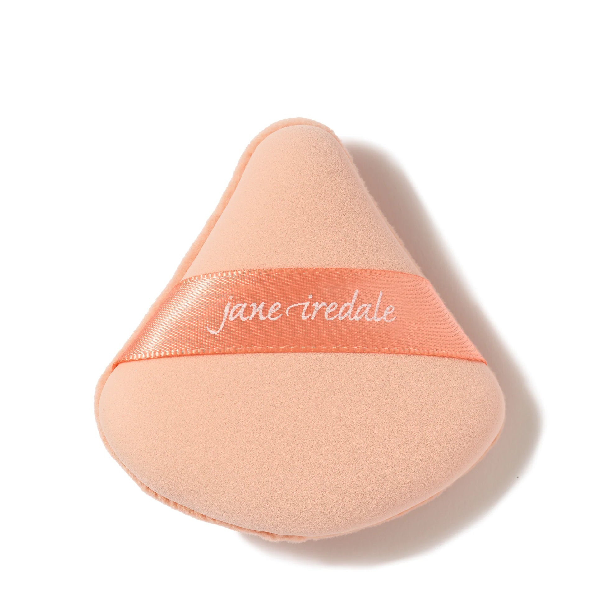 Perfect & Set™ Dual-Sided Puff by jane iredale, a peach-colored triangular makeup sponge designed for flawless makeup application and shine control.