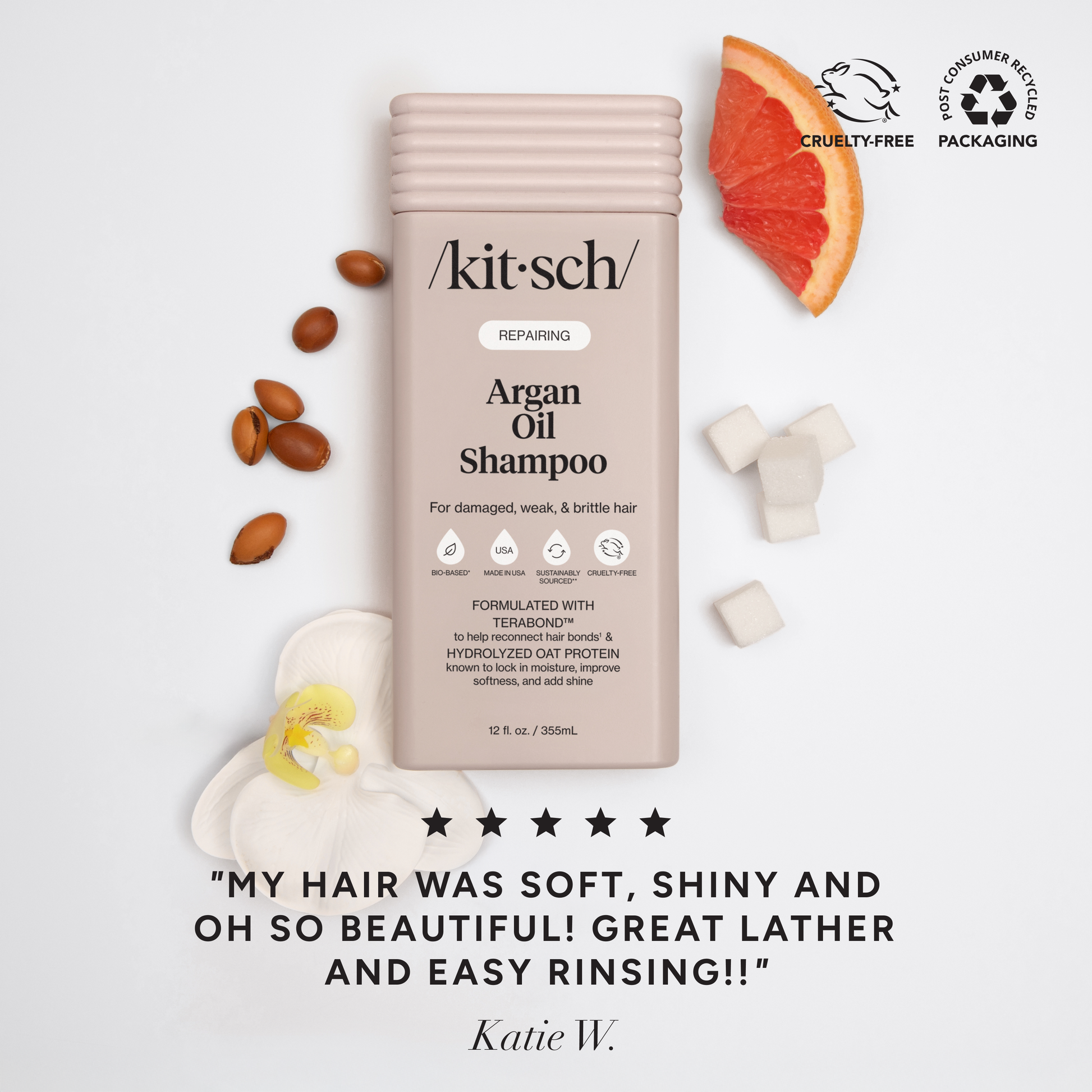 Repairing Argan Oil Shampoo bottle with argan nuts, grapefruit slice, orchid, and sugar cubes, highlighting bio-based, cruelty-free features for damaged hair care.