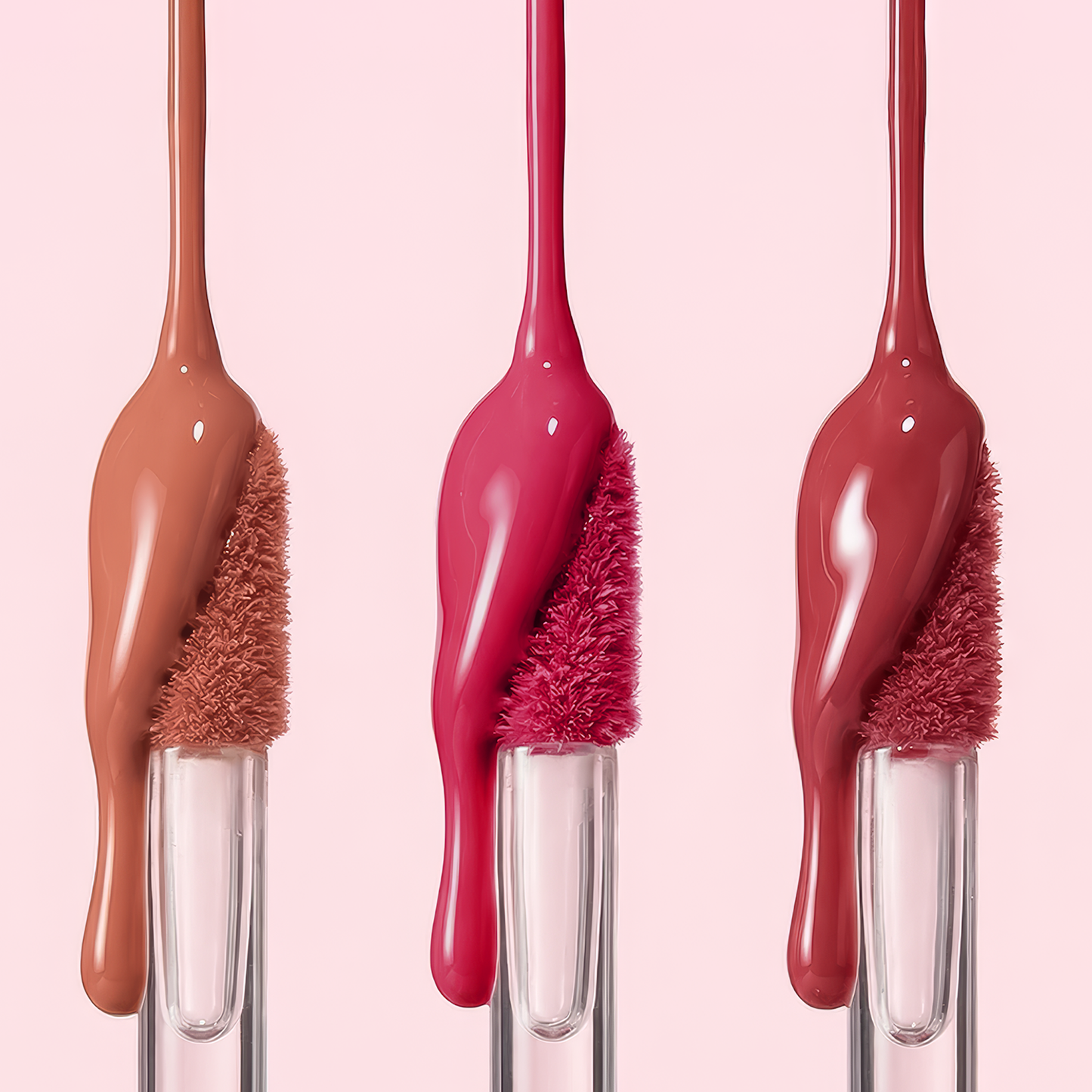 SPF 40 Nourishing Lip Serum applicators with warm nude, bright pink, and deep rose shades, showcasing glossy, oozing formula for hydrated, protected lips.