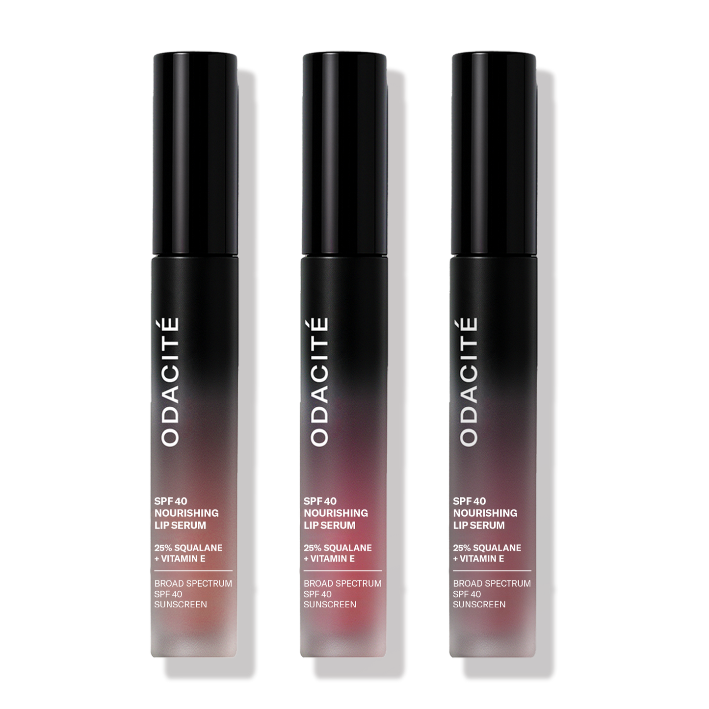 Three tubes of Odacité SPF 40 Nourishing Lip Serum with mineral Zinc Oxide, offering hydration, UV protection, and buildable color with a satin finish.