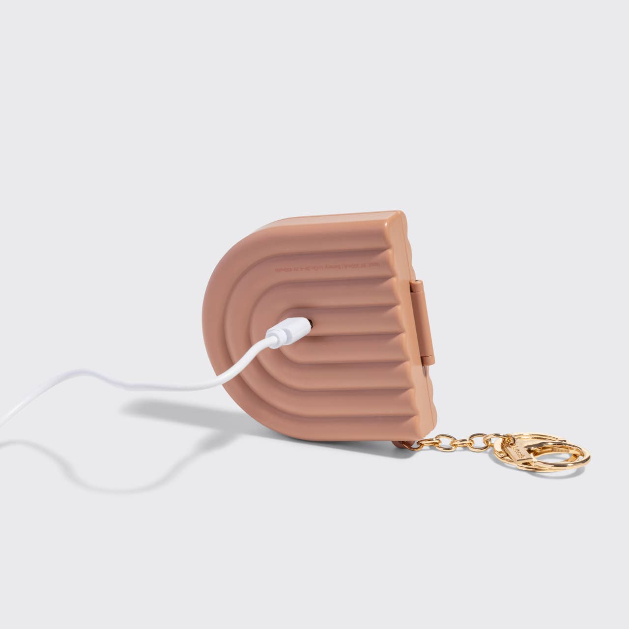 Terracotta Compact Mirror Keychain with ribbed surface, USB cable, and keychain clip, ideal for travel.
