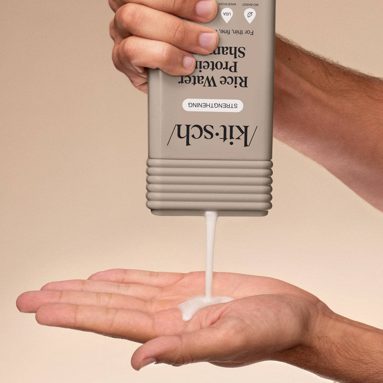 Hands dispensing Kitsch Strengthening Rice Water Shampoo, showcasing its creamy texture; designed to enhance shine and volume in hair, suitable for clean beauty enthusiasts.