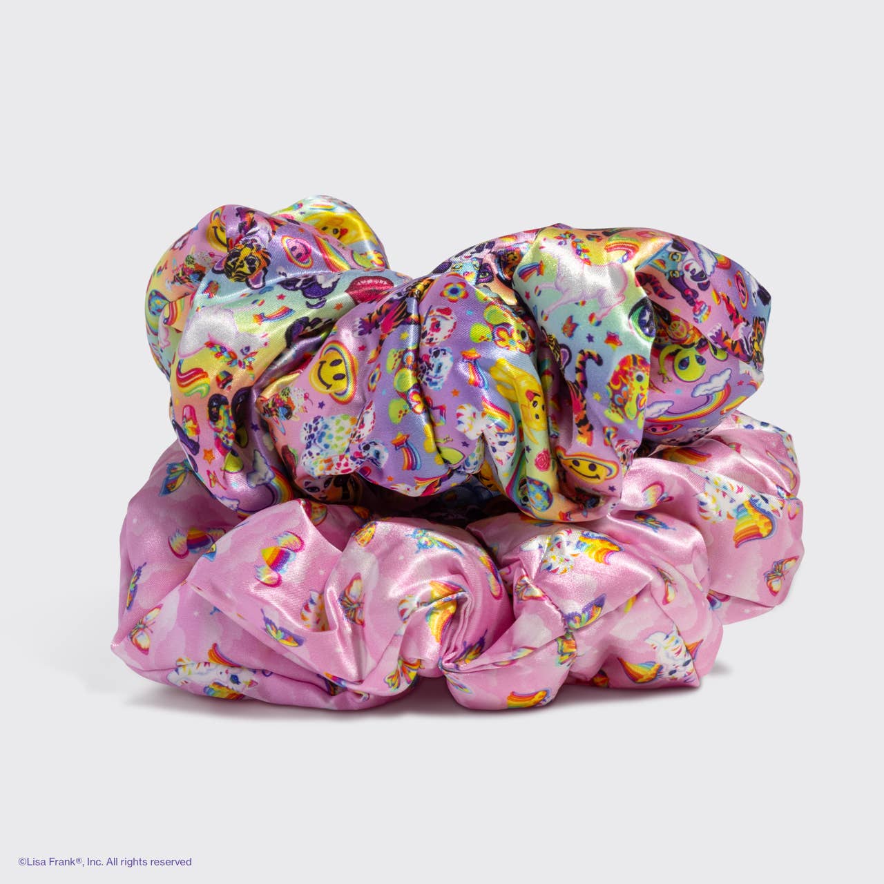 Lisa Frank x Kitsch Pillow Scrunchies® in Satin showcasing a multicolored and pink unicorn-rainbow print, offering gentle, snag-free hold for all hair types.