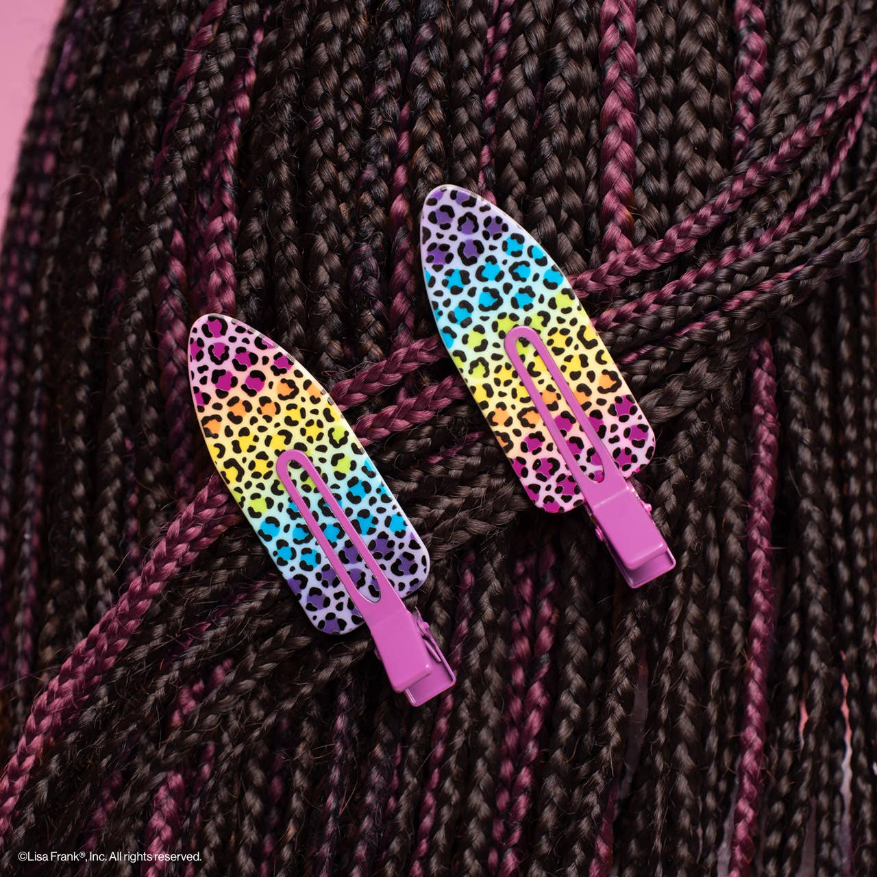 Lisa Frank x Kitsch XL Creaseless Clips in Rainbow Leopard secure braided hair with rainbow-gradient leopard pattern, hot-pink hinges; ideal for makeup application without creasing.