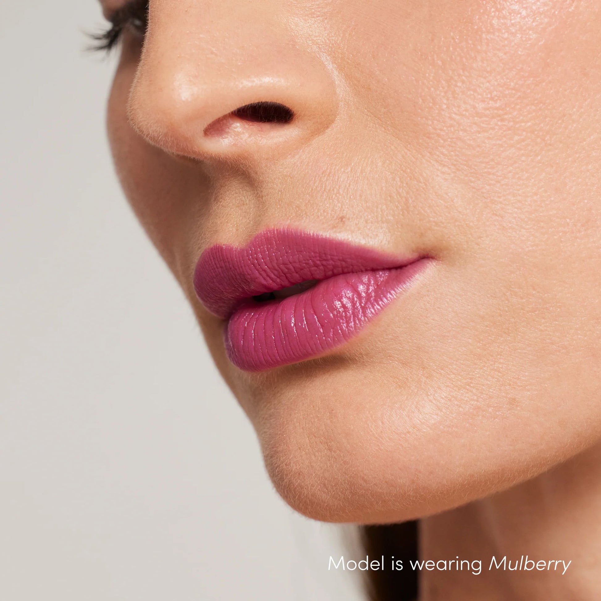 Close-up of lips wearing ColorLuxe Hydrating Cream Lipstick in Mulberry, showcasing its creamy, vibrant finish and natural skin texture.