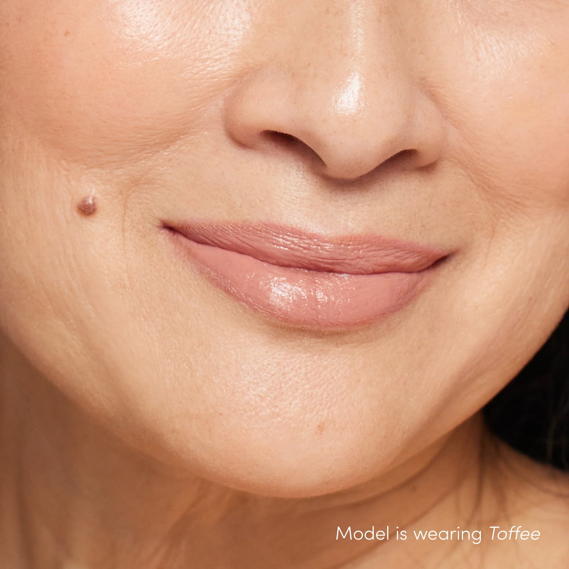 Close-up of lips wearing ColorLuxe Hydrating Cream Lipstick in Toffee, showcasing its creamy, glossy finish and rich, vibrant color.