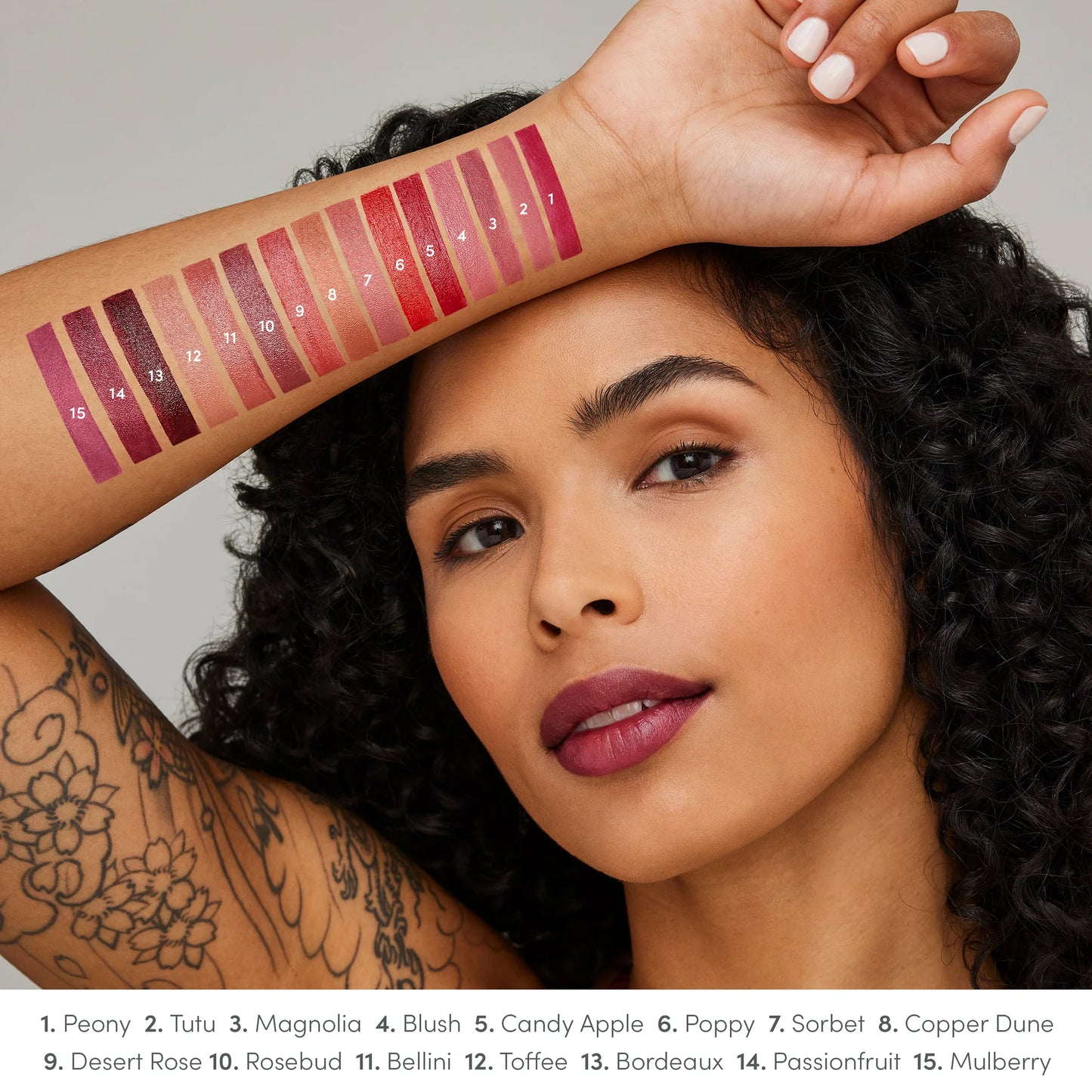 Model showcasing ColorLuxe Hydrating Cream Lipstick's 15 shades on face and forearm, highlighting rich, vibrant colors and creamy, hydrating formula for all-day comfort.