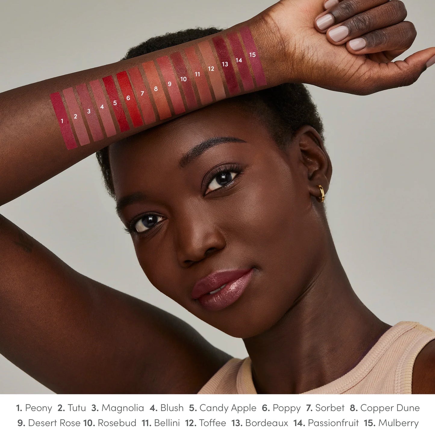 Model displays 15 ColorLuxe Hydrating Cream Lipstick swatches on arm, showcasing shades from pinks to berries. Creamy, hydrating, and vibrant for all-day comfort.
