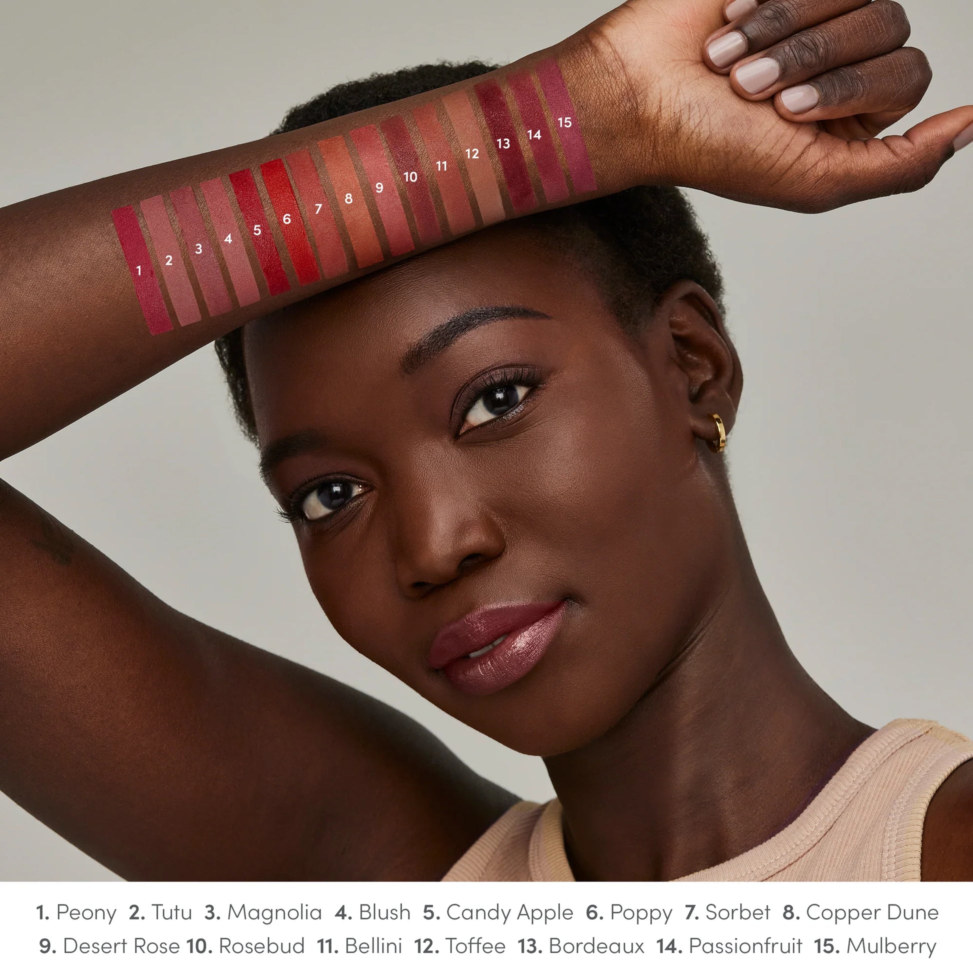 Model displays 15 ColorLuxe Hydrating Cream Lipstick swatches on arm, showcasing shades from pinks to berries. Creamy, hydrating, and vibrant for all-day comfort.