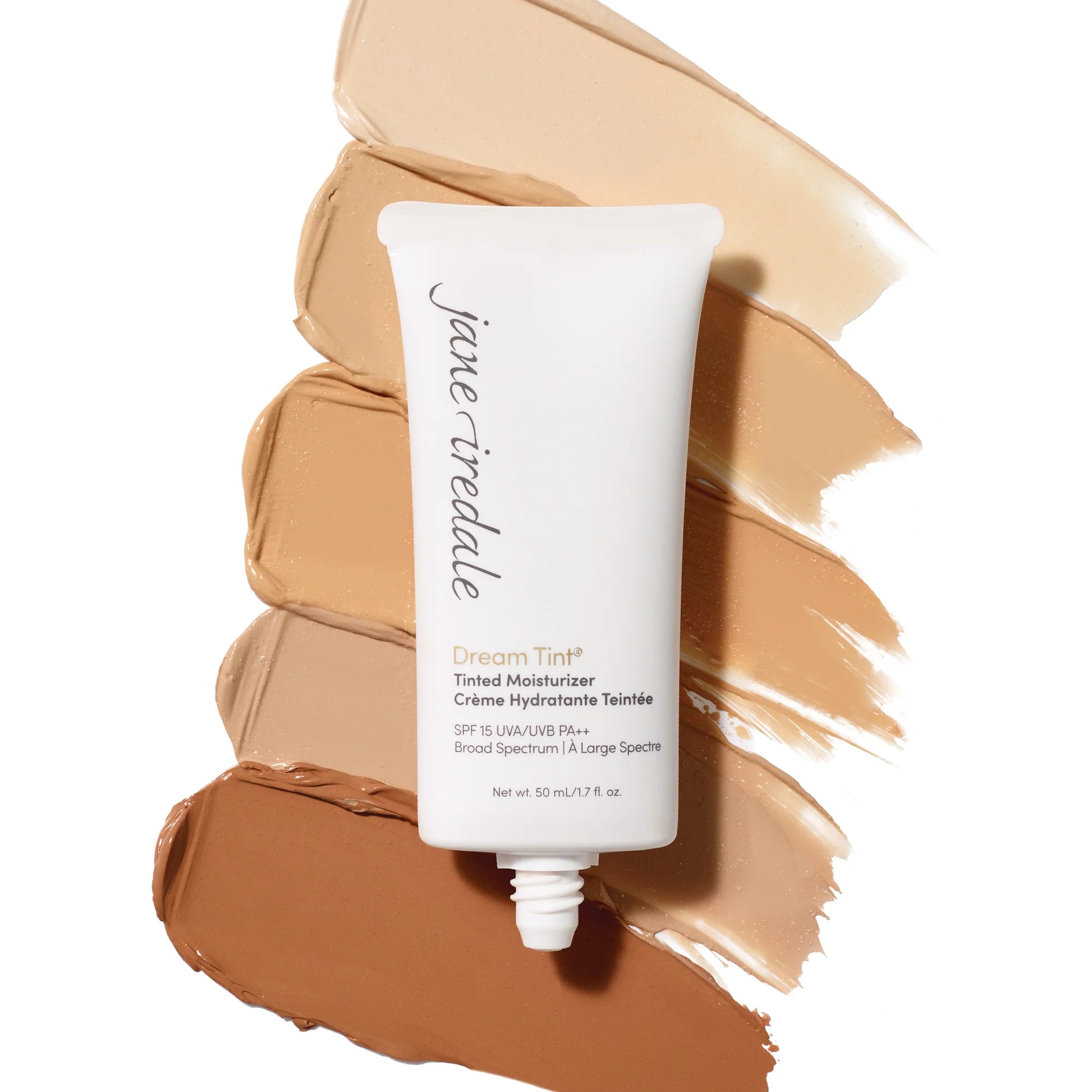 Jane Iredale's Dream Tint® Tinted Moisturizer SPF 15 tube displayed on skin-tone swatches, highlighting its lightweight, hydrating, natural finish suitable for a 'no-makeup' look.