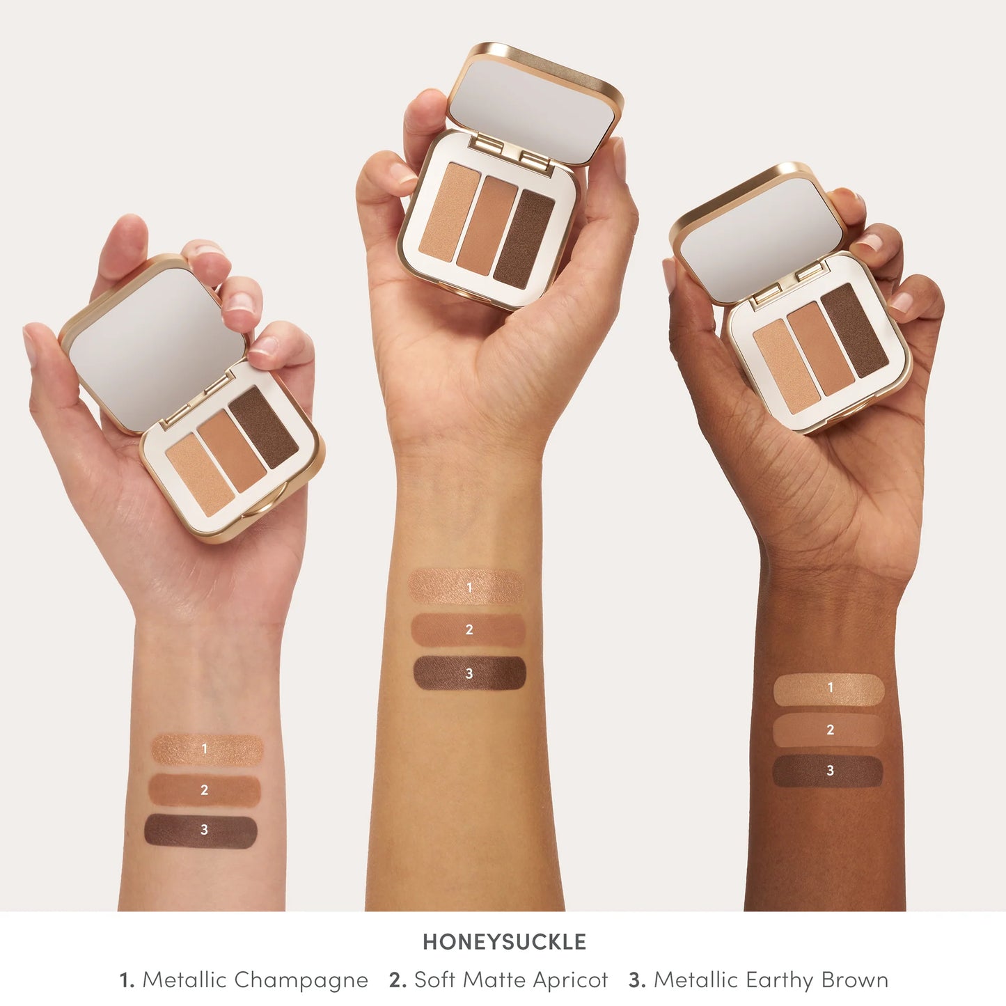 PurePressed® Eye Shadow Triple in Honeysuckle, featuring three shades, is displayed open in hands with swatches on diverse arms, highlighting its versatility and harmonious colors.
