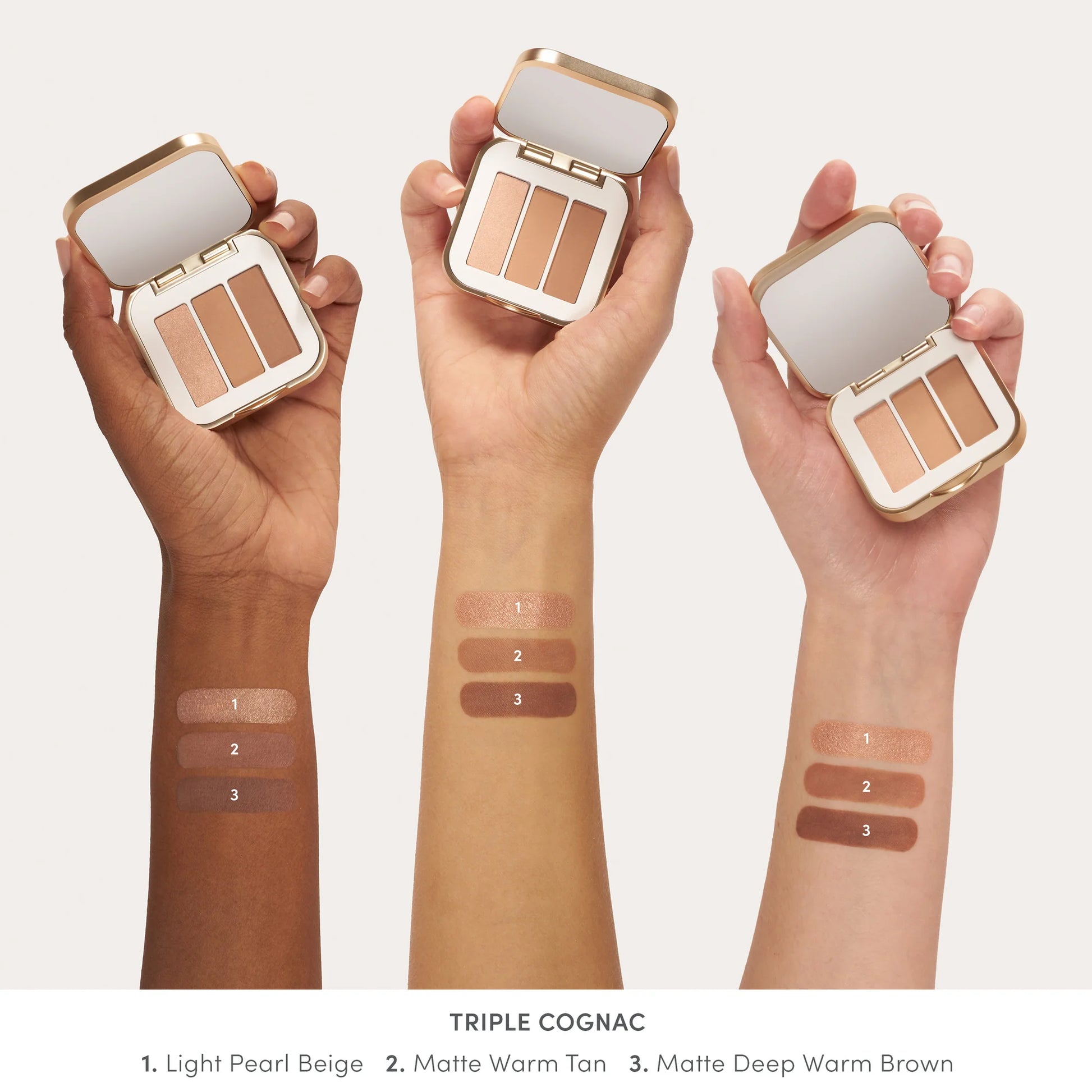 PurePressed® Eye Shadow Triple in Triple Cognac held by diverse hands, showcasing three warm shades and swatches, highlighting its versatile, talc-free, vegan formula.