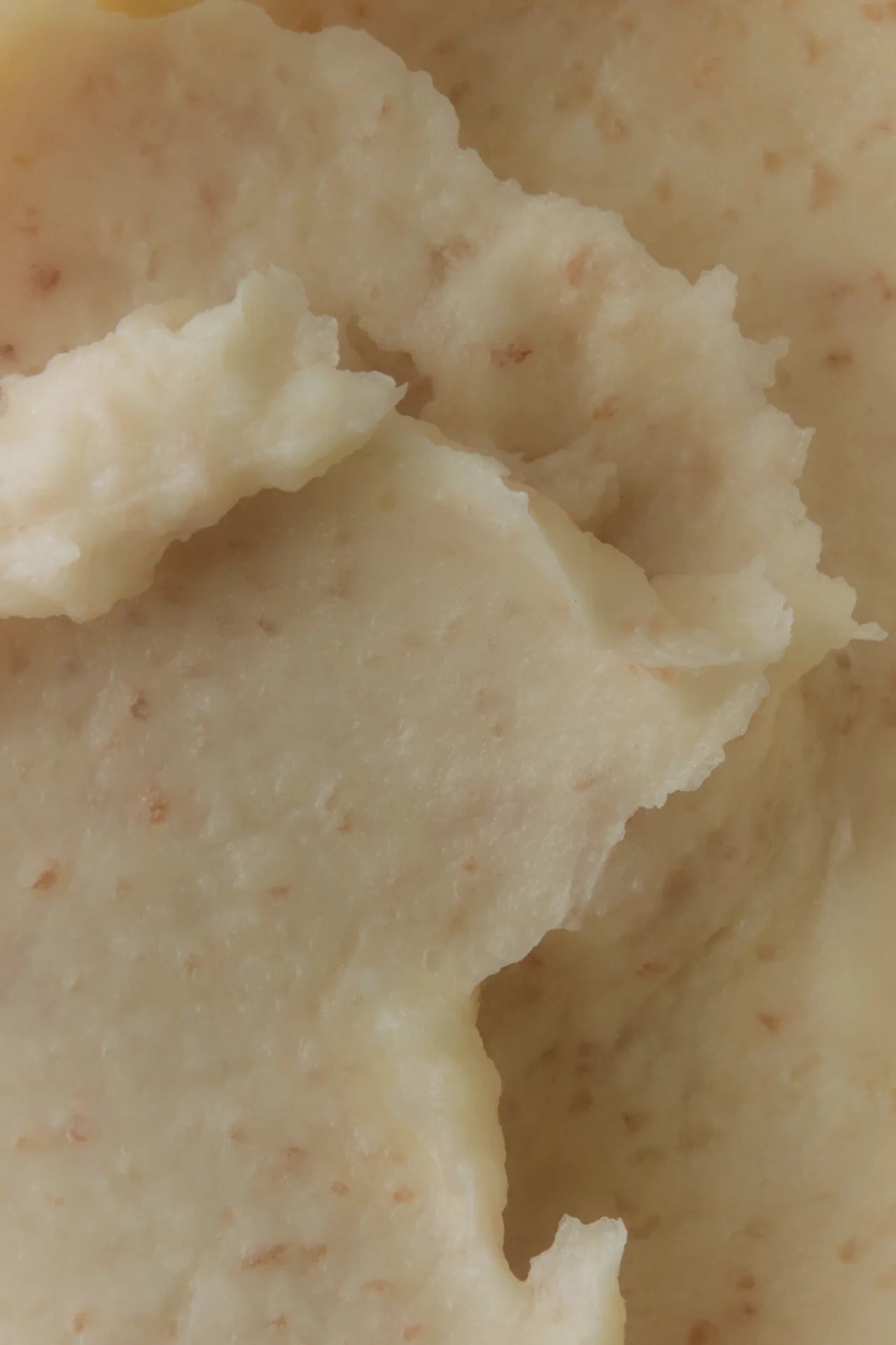 Salt Scalp Scrub Exfoliating Shampoo close-up, showcasing a pale, grainy texture, symbolizing its exfoliating mineral salts and creamy, nourishing formula for balanced scalp care.