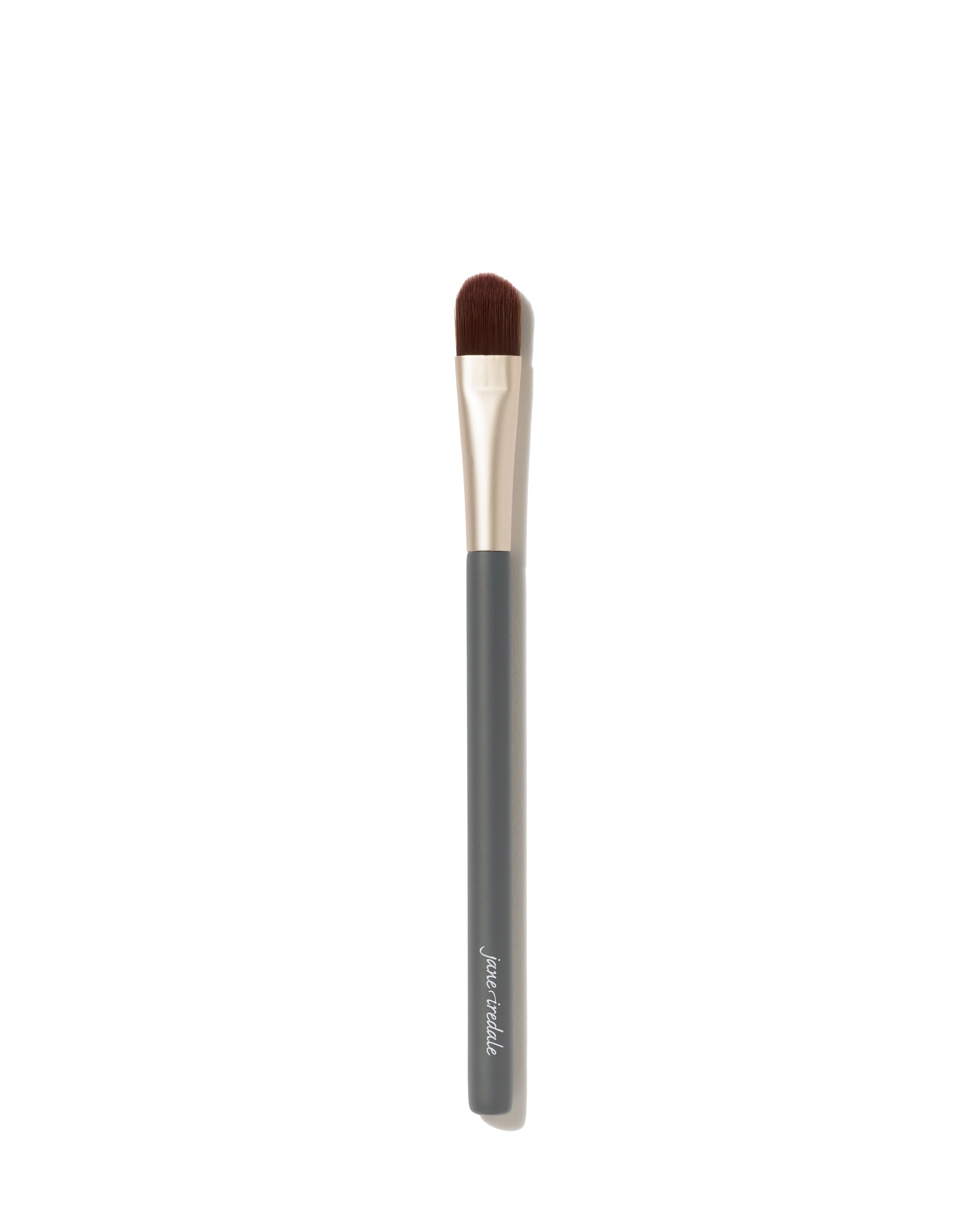 Camouflage Brush with dark handle, metallic ferrule, flat-topped bristles for flawless concealer application; crafted for even, professional results.