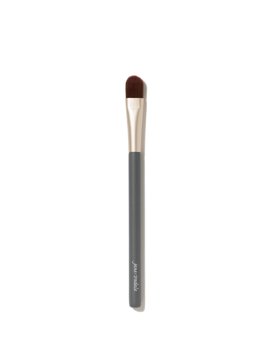 Camouflage Brush with dark handle, metallic ferrule, flat-topped bristles for flawless concealer application; crafted for even, professional results.