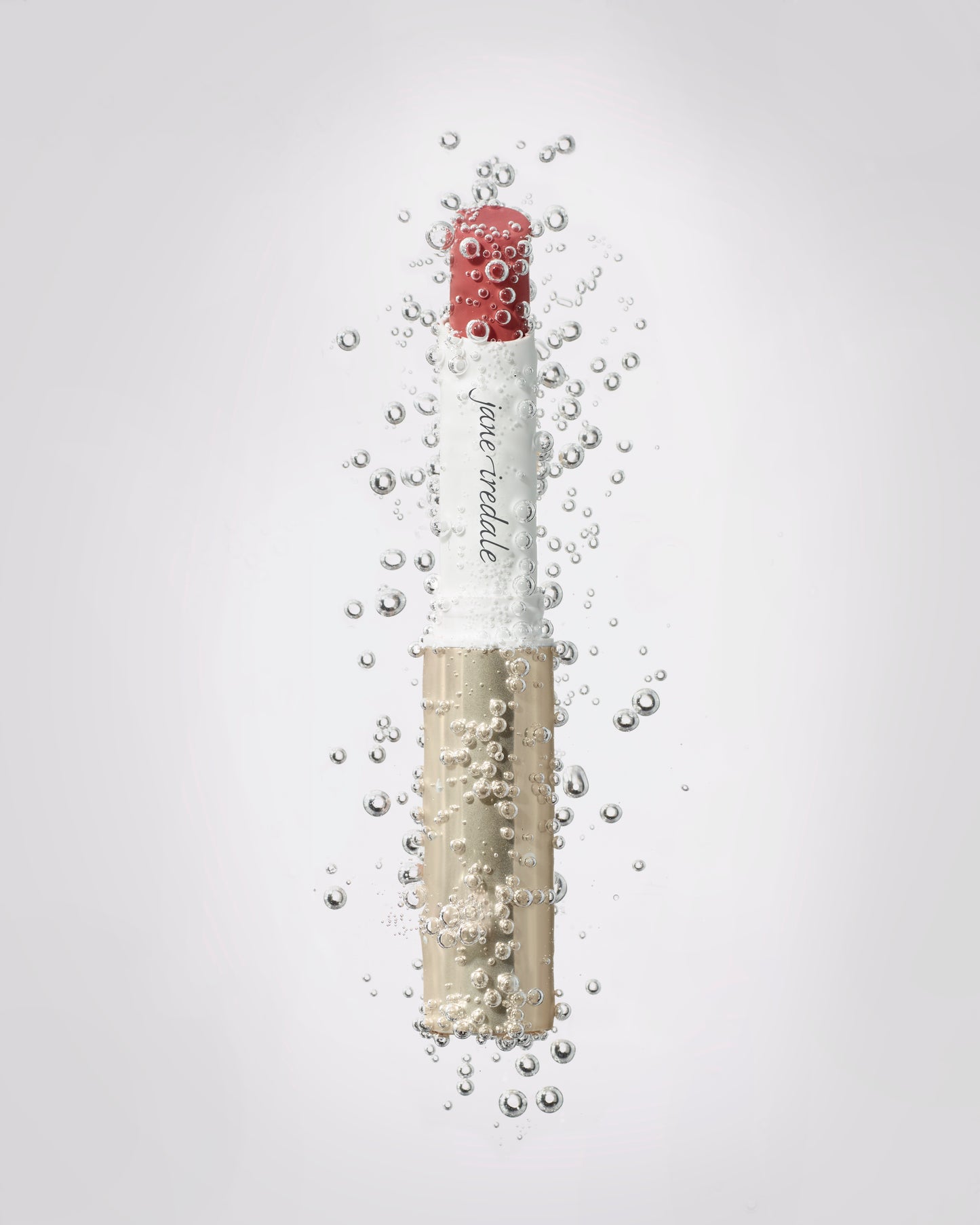ColorLuxe Hydrating Cream Lipstick by jane iredale, underwater with bubbles, offers rich, vibrant color and hydration with a luxurious satin finish.