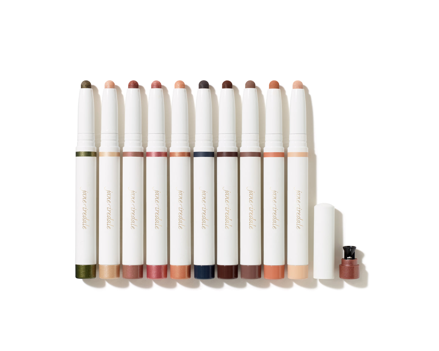 ColorLuxe Eye Shadow Stick lineup showcasing various shades; one stick uncapped with built-in sharpener. Creamy, blendable, crease-resistant formula for effortless application.