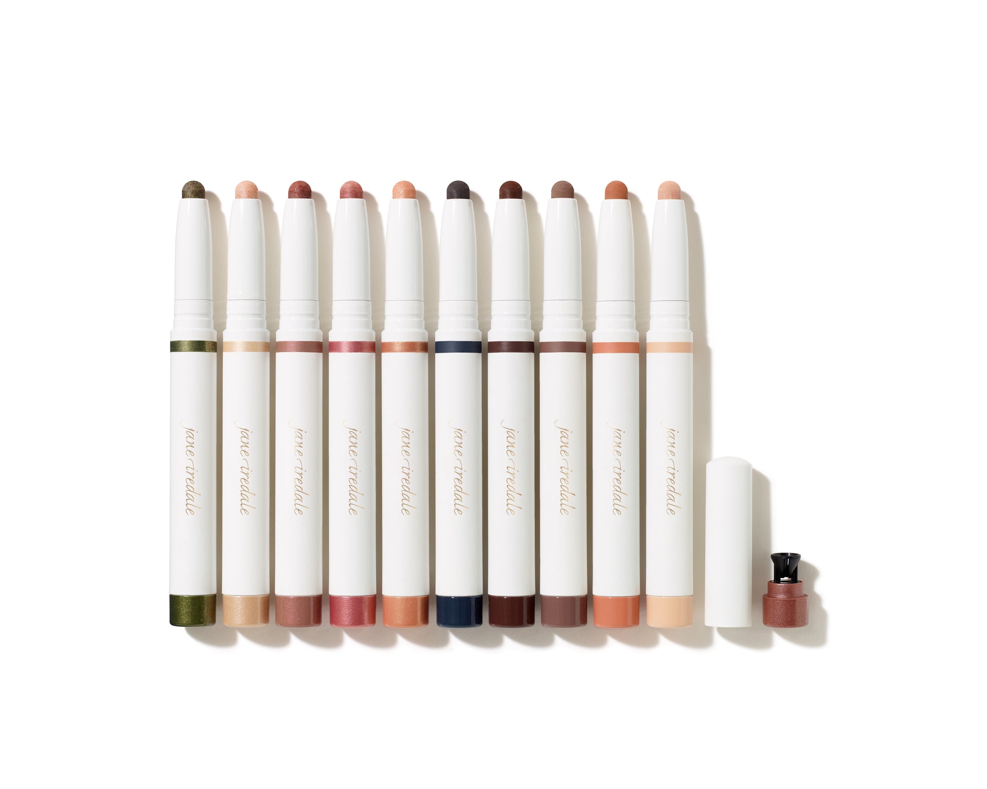 ColorLuxe Eye Shadow Stick lineup showcasing various shades; one stick uncapped with built-in sharpener. Creamy, blendable, crease-resistant formula for effortless application.