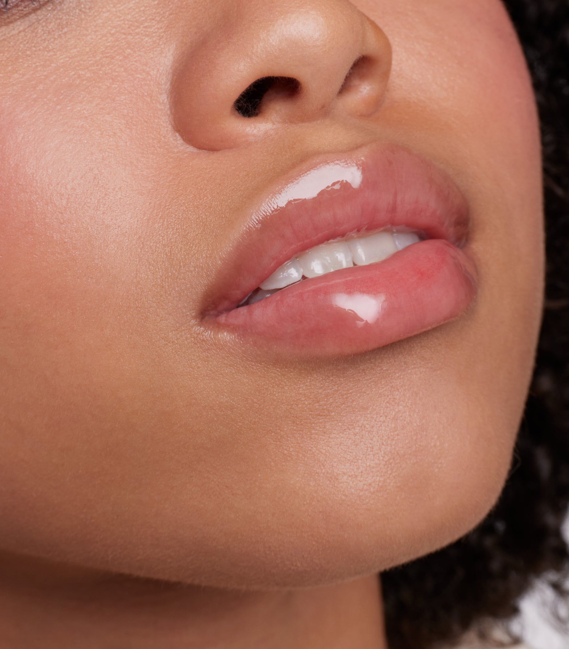 Close-up of glossy pink lips showcasing the ColorLuxe High Impact Lip Glaze, highlighting its bold pigmentation and nourishing, glossy finish.
