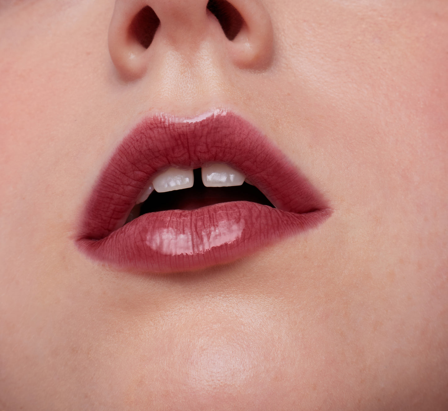 Close-up of lips wearing ColorLuxe High Impact Lip Glaze, showcasing its glossy finish and rich pigmentation, highlighting the product's nourishing, comfortable wear.