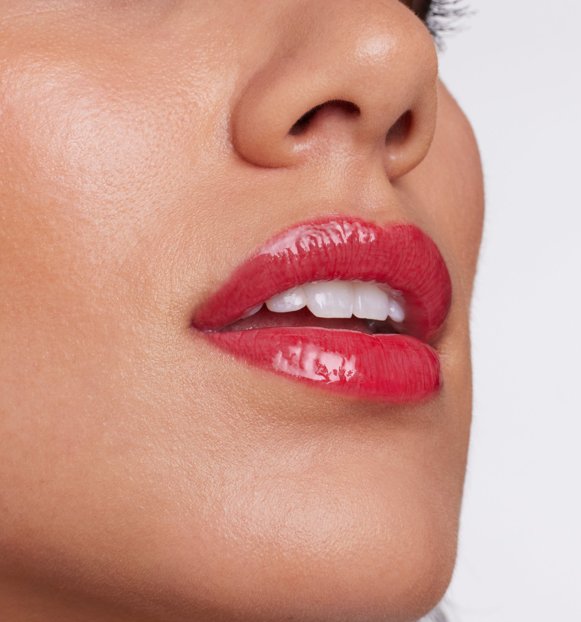 ColorLuxe High Impact Lip Glaze showcases glossy red lips with high pigmentation, offering a bold, comfortable, and nourishing finish for a striking beauty statement.