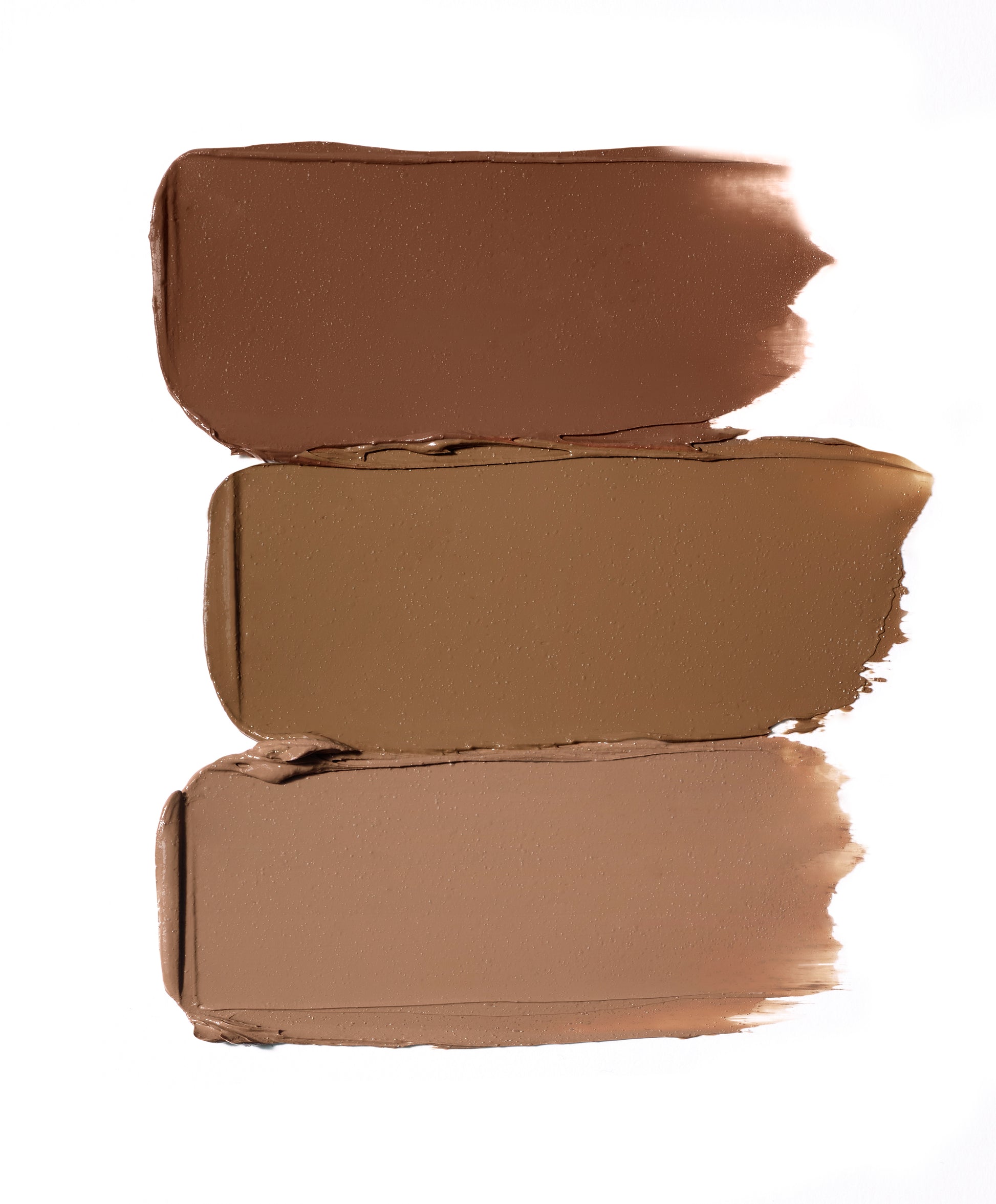 Glow Time® Bronzer Stick swatches in three brown tones, showcasing buildable, creamy formula for a natural, sun-kissed glow.