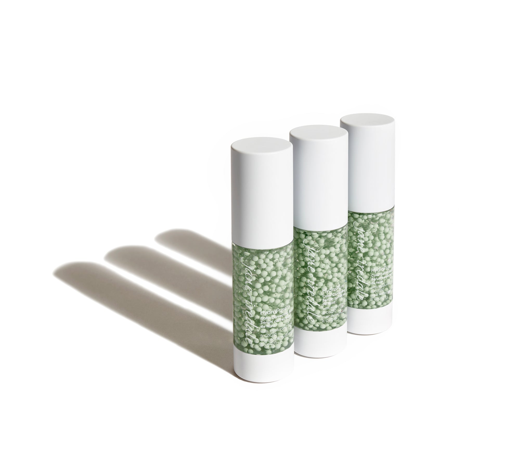 HydroPure™ Color Correcting Serum bottles showcasing suspended pale-green beads in gel, highlighting skincare and color correction benefits with Hyaluronic Acid and CoQ10.