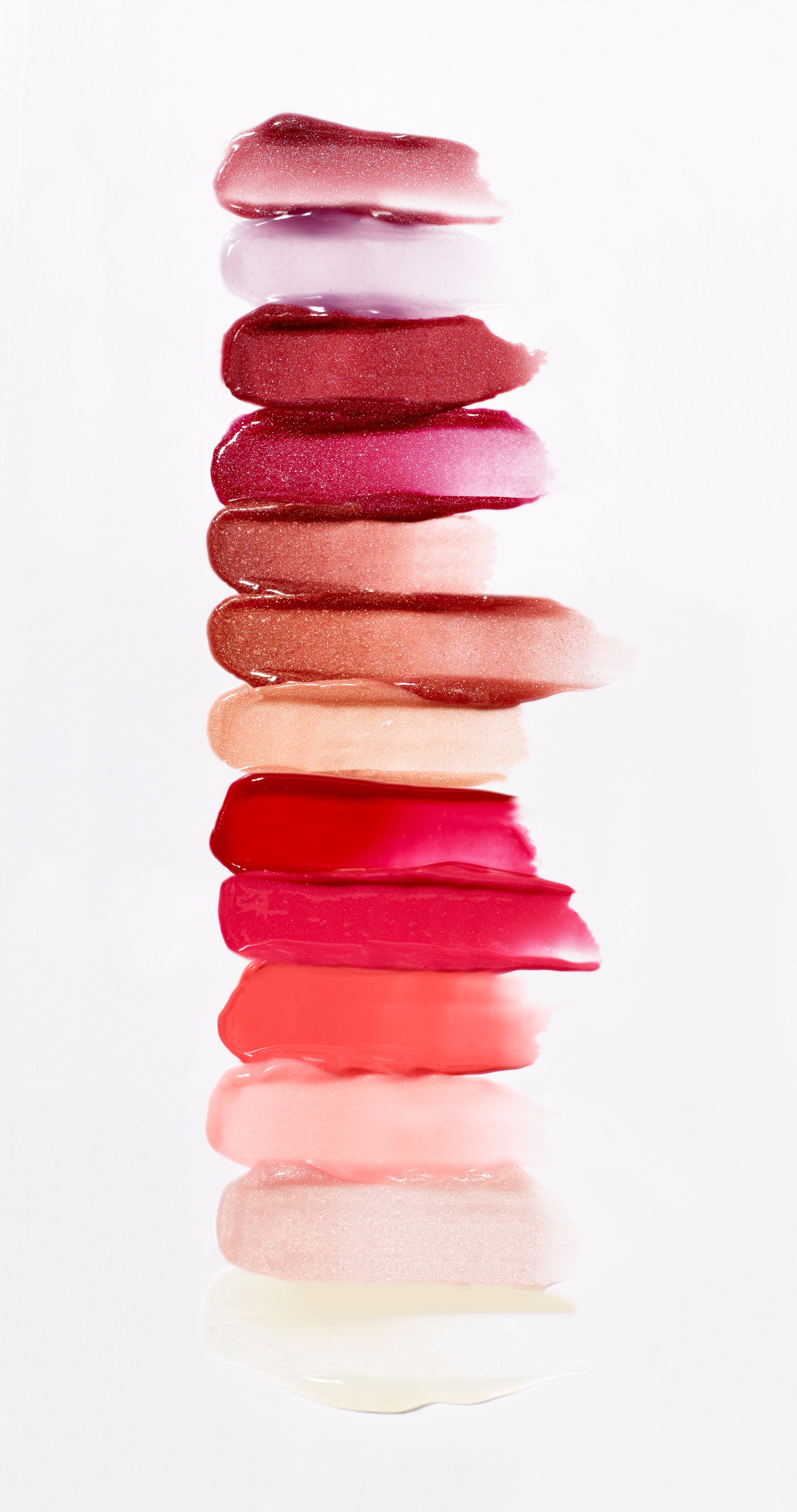 HydroPure™ Hyaluronic Acid Lip Gloss swatches showcase glossy, versatile shades from bold berries to subtle nudes, highlighting its hydrating, plumping formula.