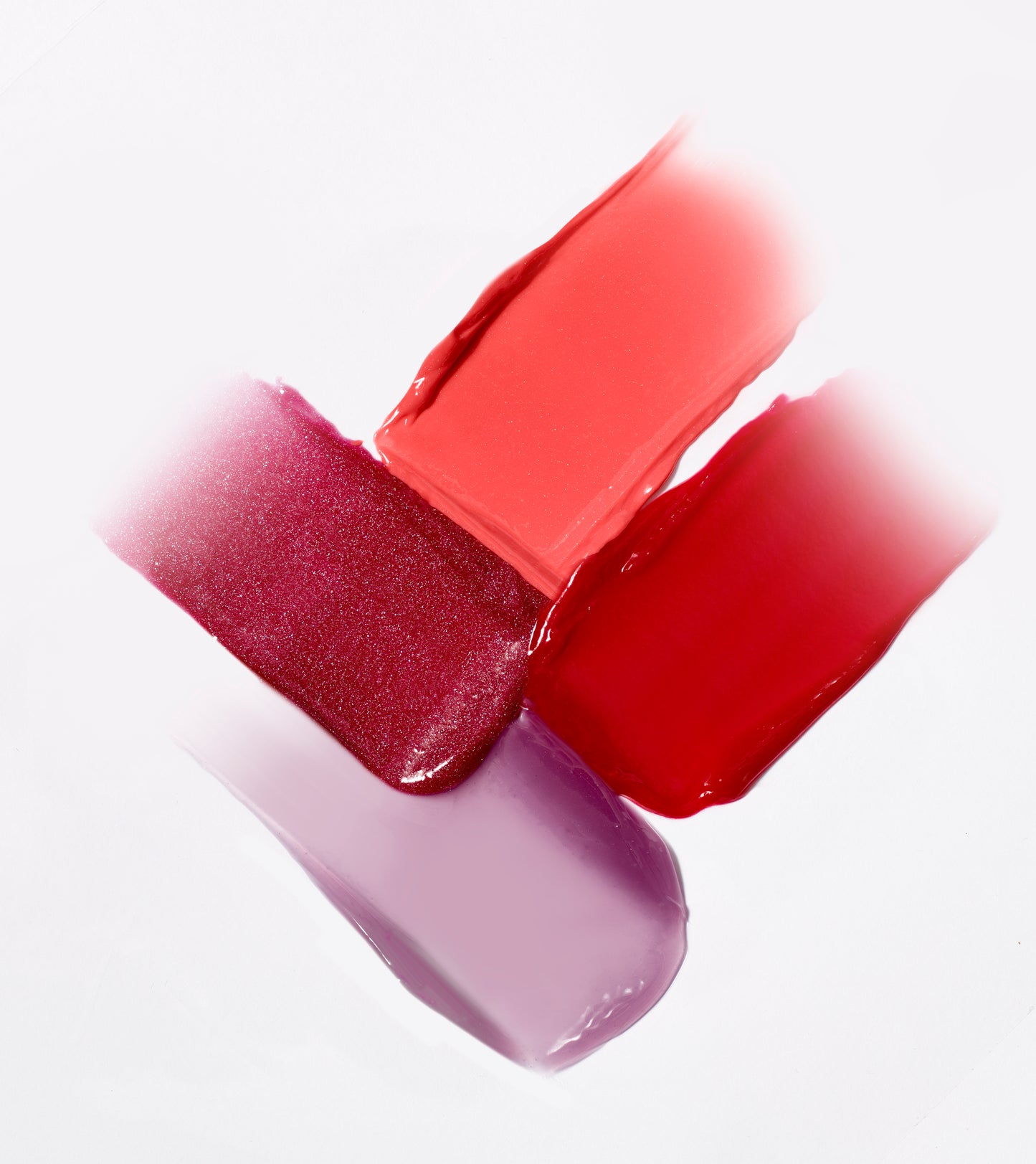 HydroPure™ Hyaluronic Acid Lip Gloss swatches showcasing four vibrant, glossy shades, highlighting the product's high-shine, hydrating, and plumping benefits.