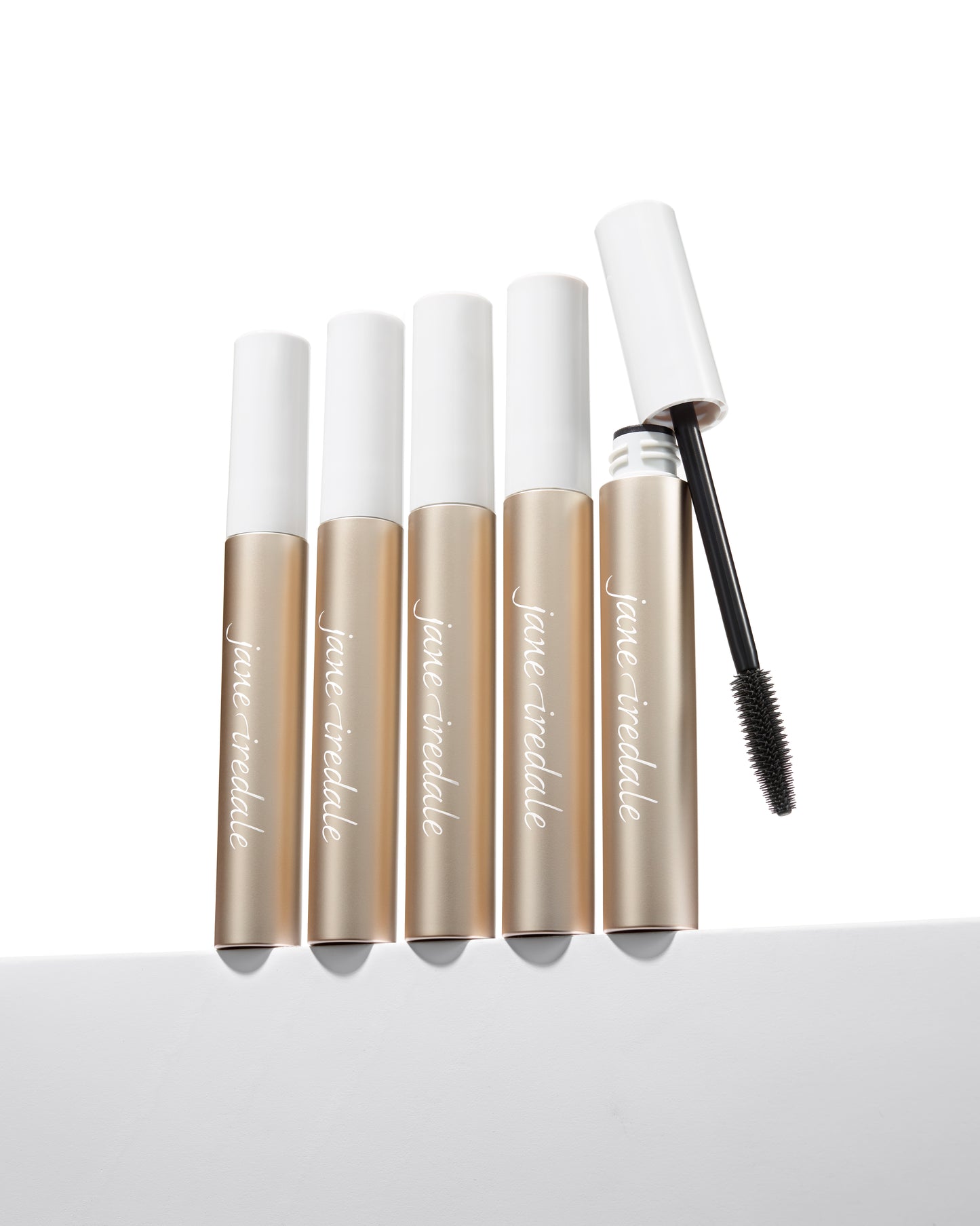 Lash Fixation Length & Definition Tubing Mascara by jane iredale, five tubes displayed, one uncapped showing the wand, offering smudge-proof, easy removal lengthening.