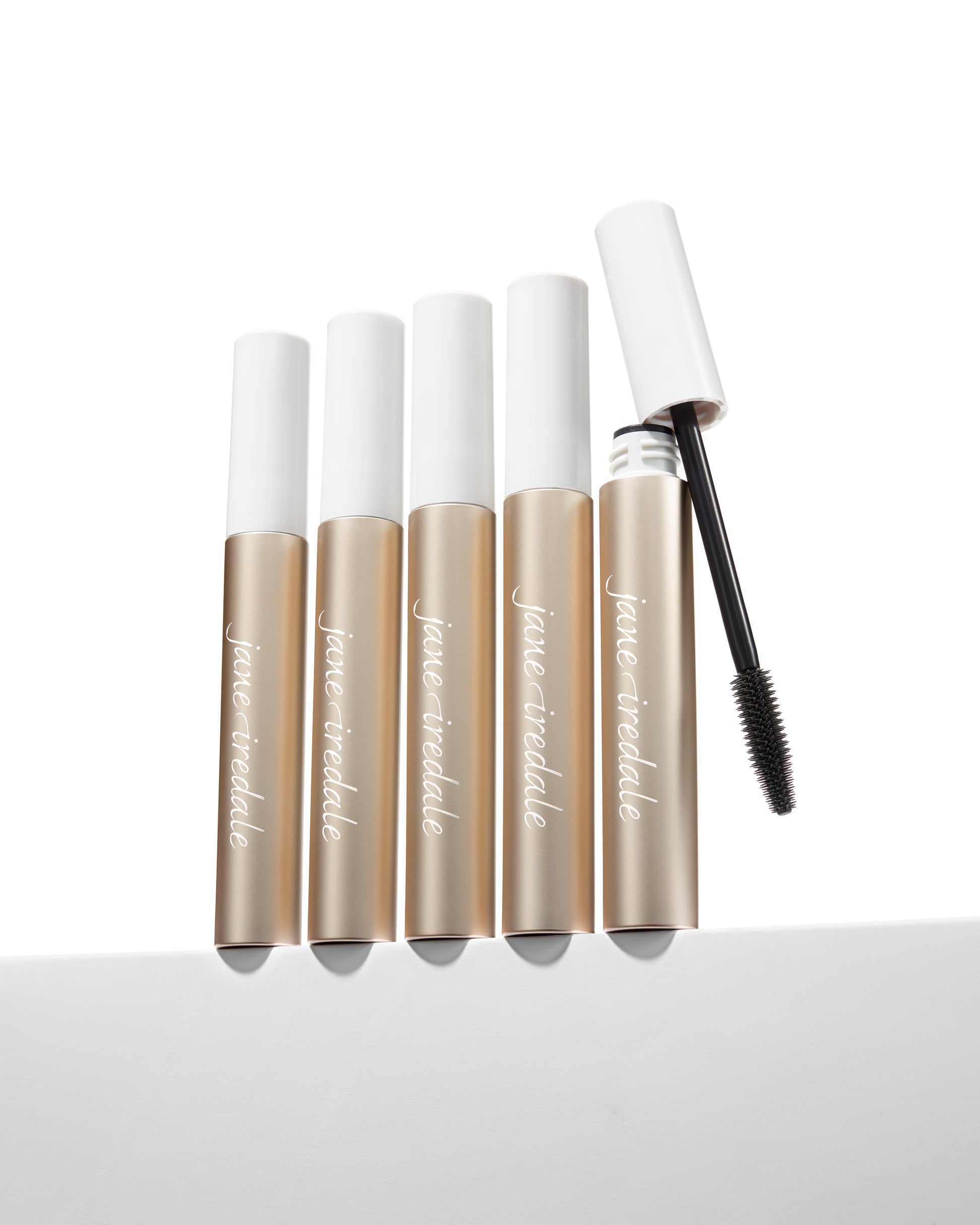 Lash Fixation Length & Definition Tubing Mascara by jane iredale, five tubes displayed, one uncapped showing the wand, offering smudge-proof, easy removal lengthening.