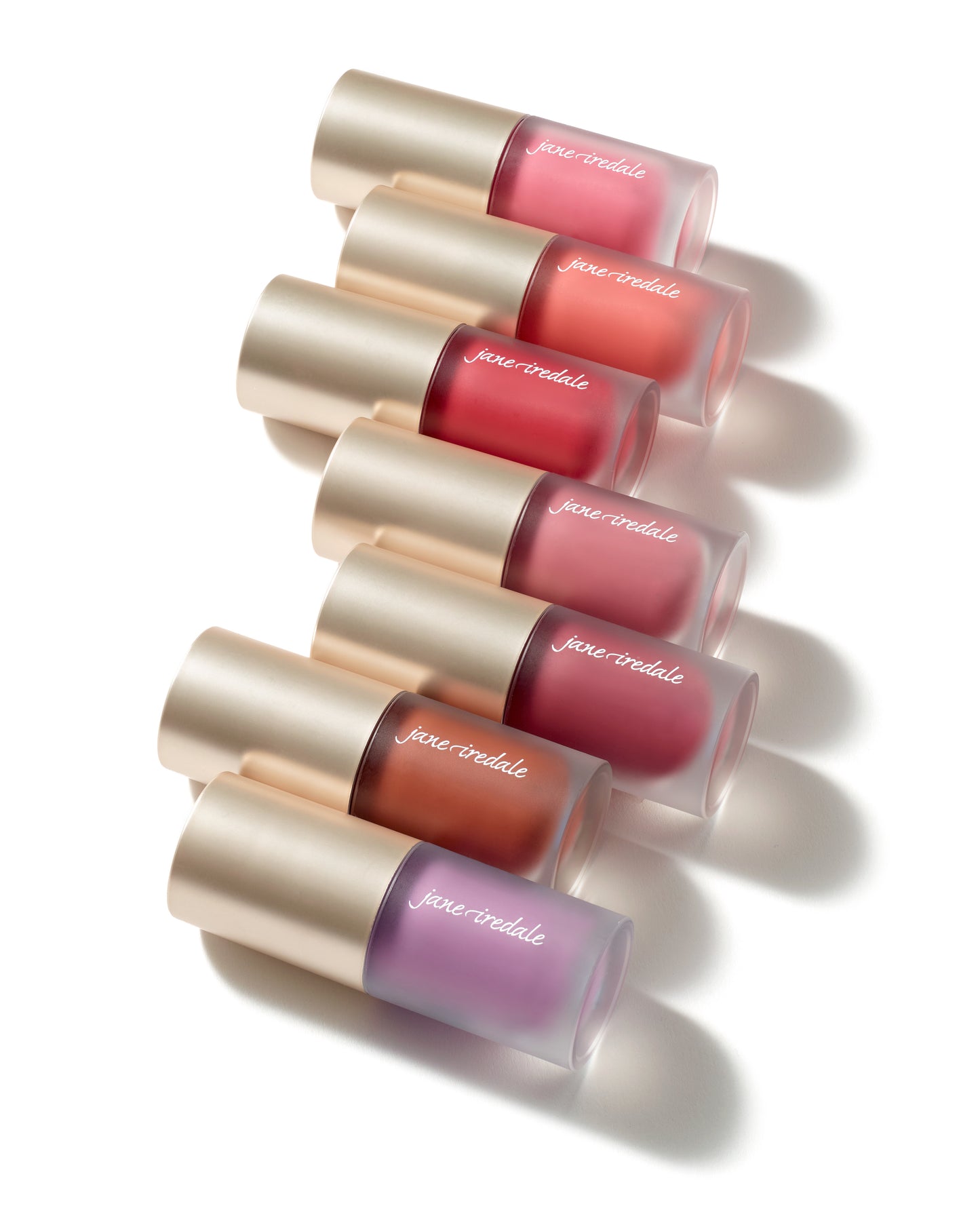 ColorLuxe Liquid Blush in frosted-glass tubes with gold caps, showcasing buildable, seamless, and long-lasting blush for a natural flush by Jane Iredale.