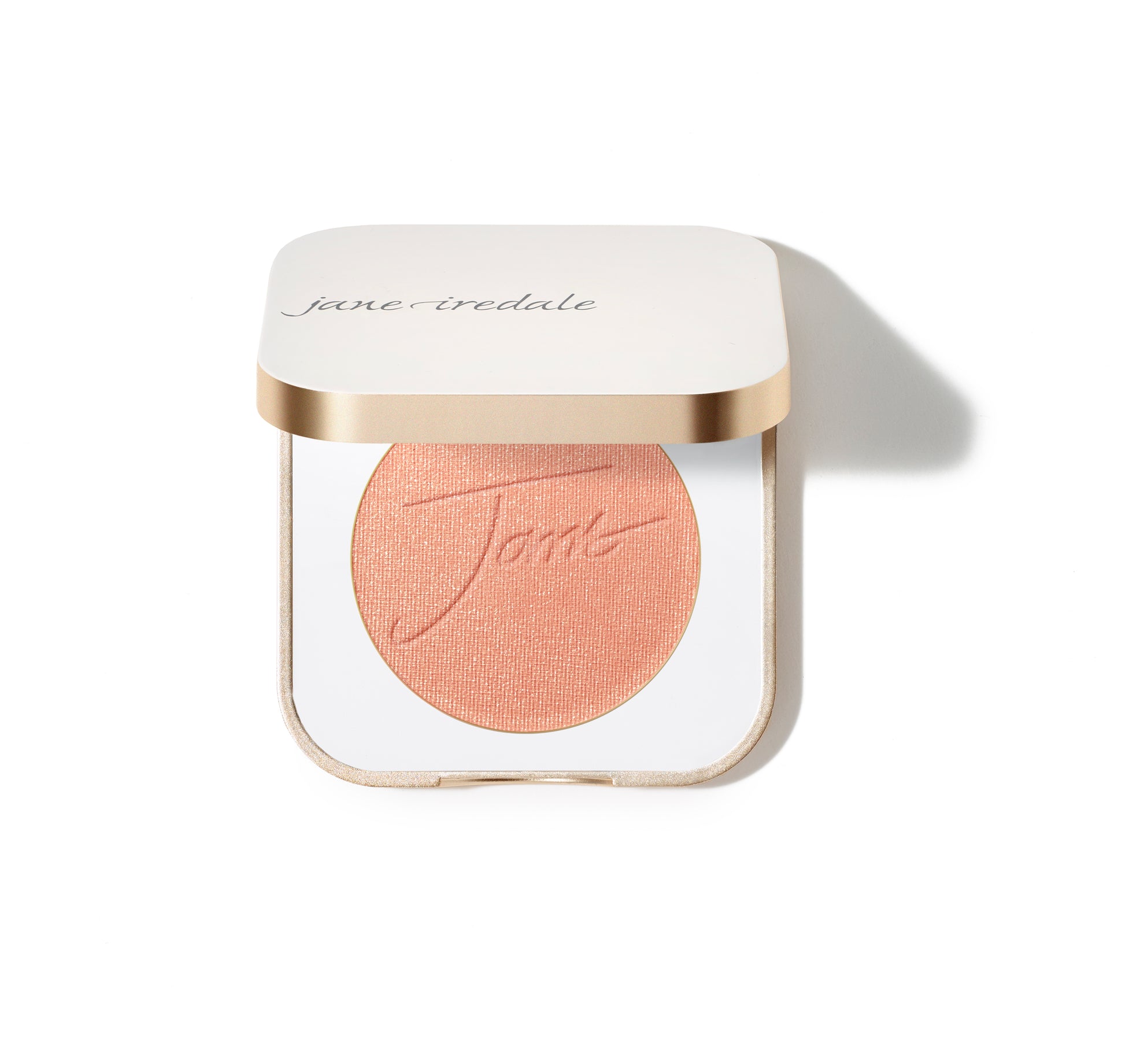 PurePressed® Blush compact, open to show a warm peach/coral pressed-powder blush, promising a natural flush with a silky, buildable, vegan formula.