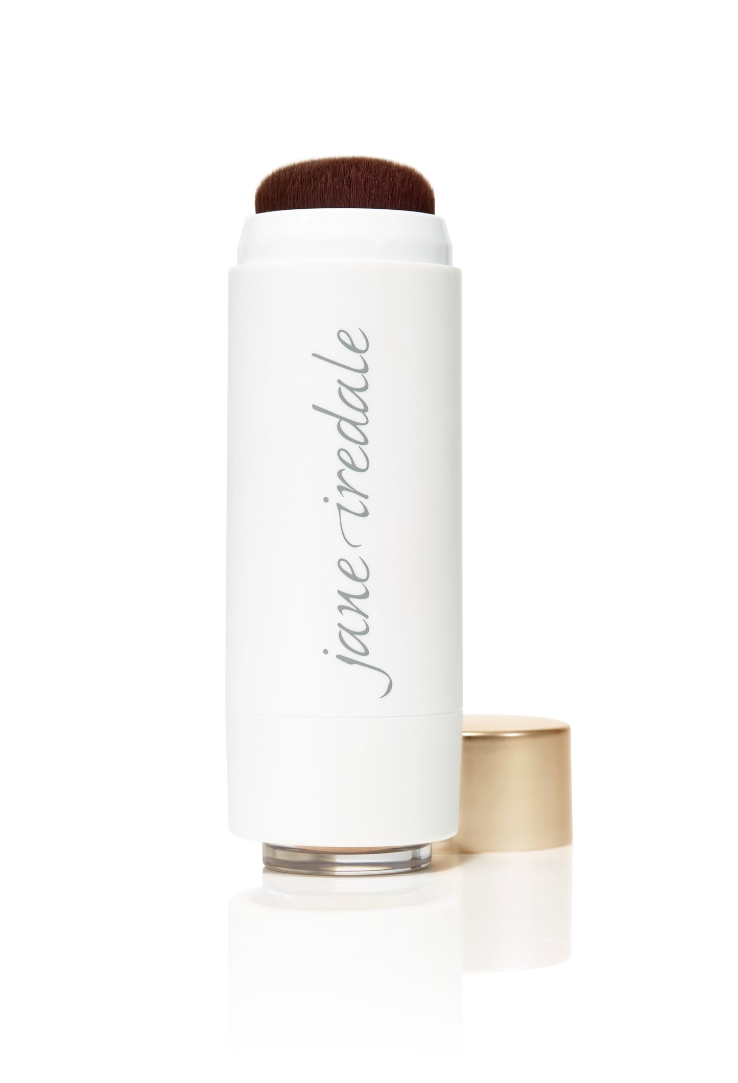 Jane Iredale Powder-Me SPF 30 Dry Sunscreen: a twist-up tube with a built-in brush for applying mineral foundation, featuring a white barrel and gold cap.