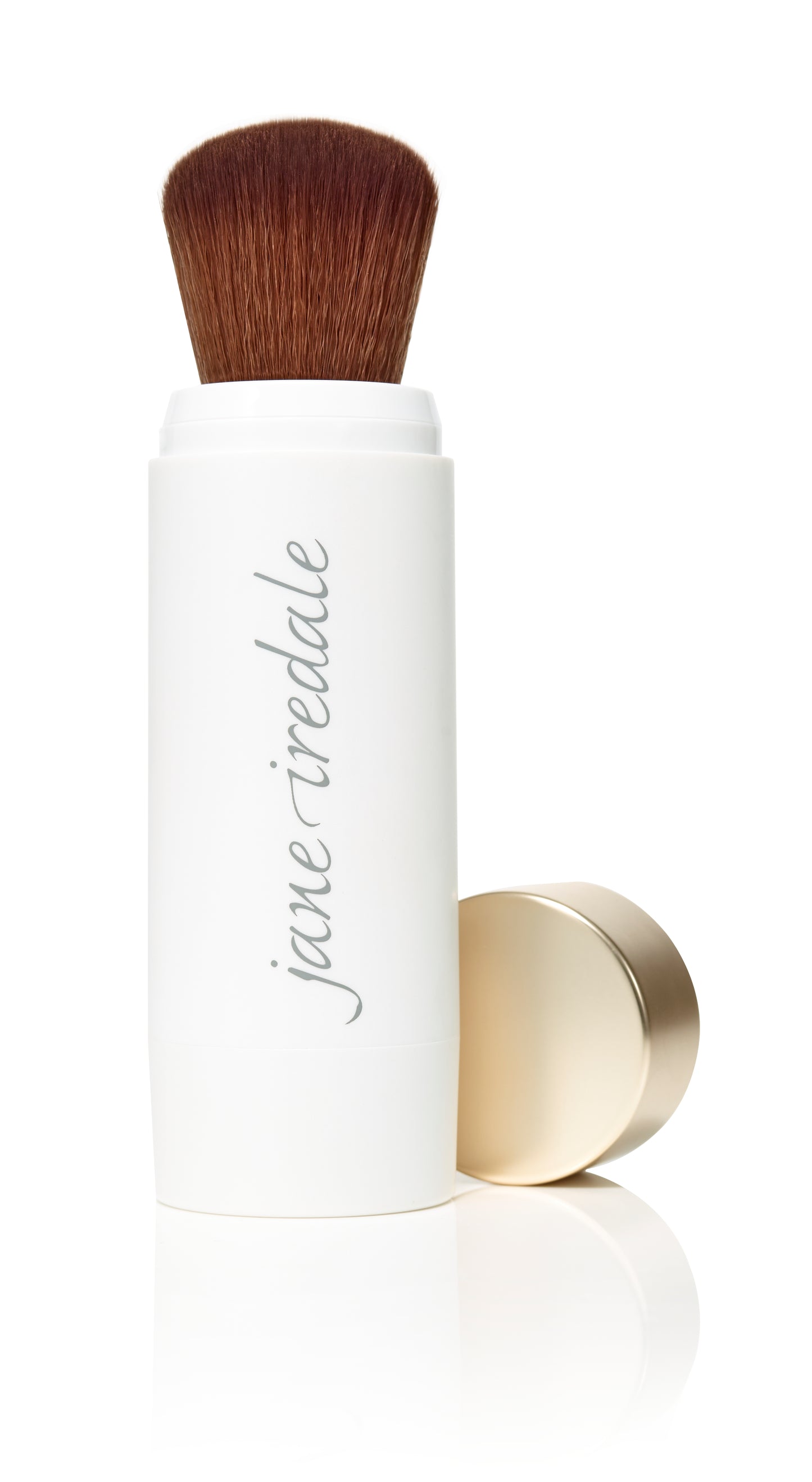 Powder-Me SPF 30 Dry Sunscreen features a retractable kabuki brush with brown bristles, housed in a white casing with jane iredale branding and a removable gold cap.