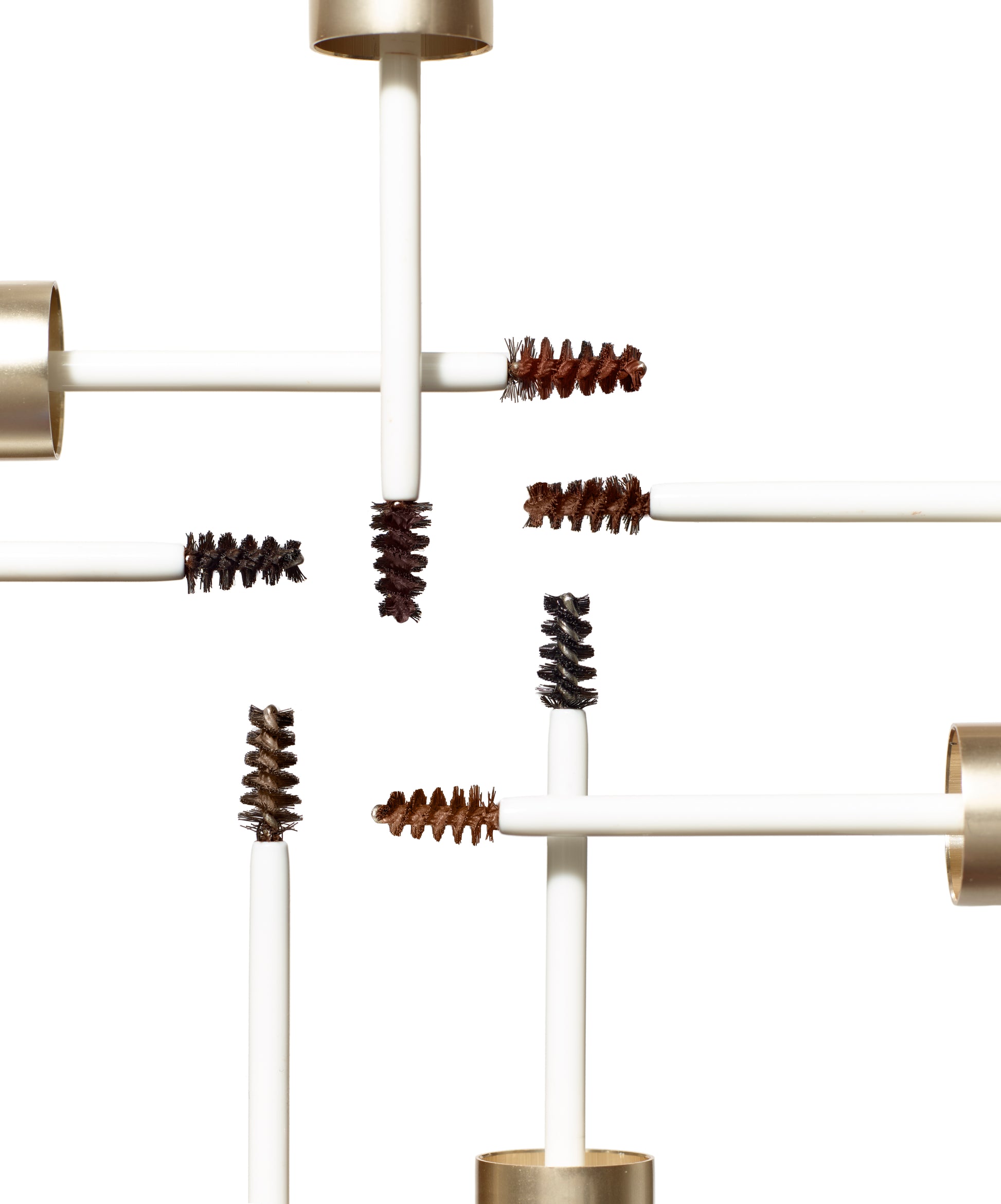 PureBrow® Brow Gel wands display in varying tints on white, showcasing precise brushes for defining and setting brows with a natural, polished finish.