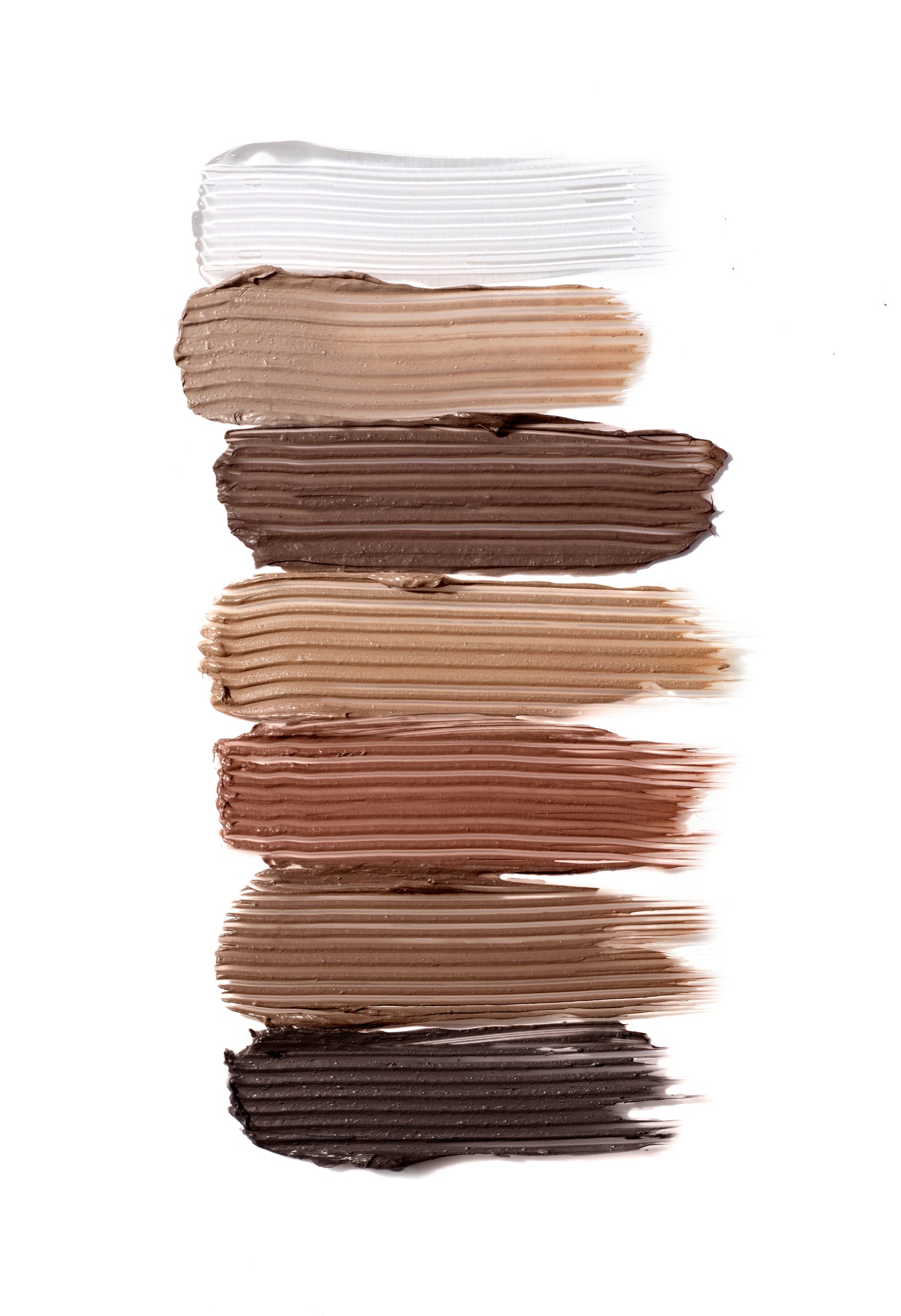 PureBrow® Brow Gel swatches in seven shades, showcasing textured strokes on a white background, highlighting the product's grooming and defining capabilities for natural, full brows.