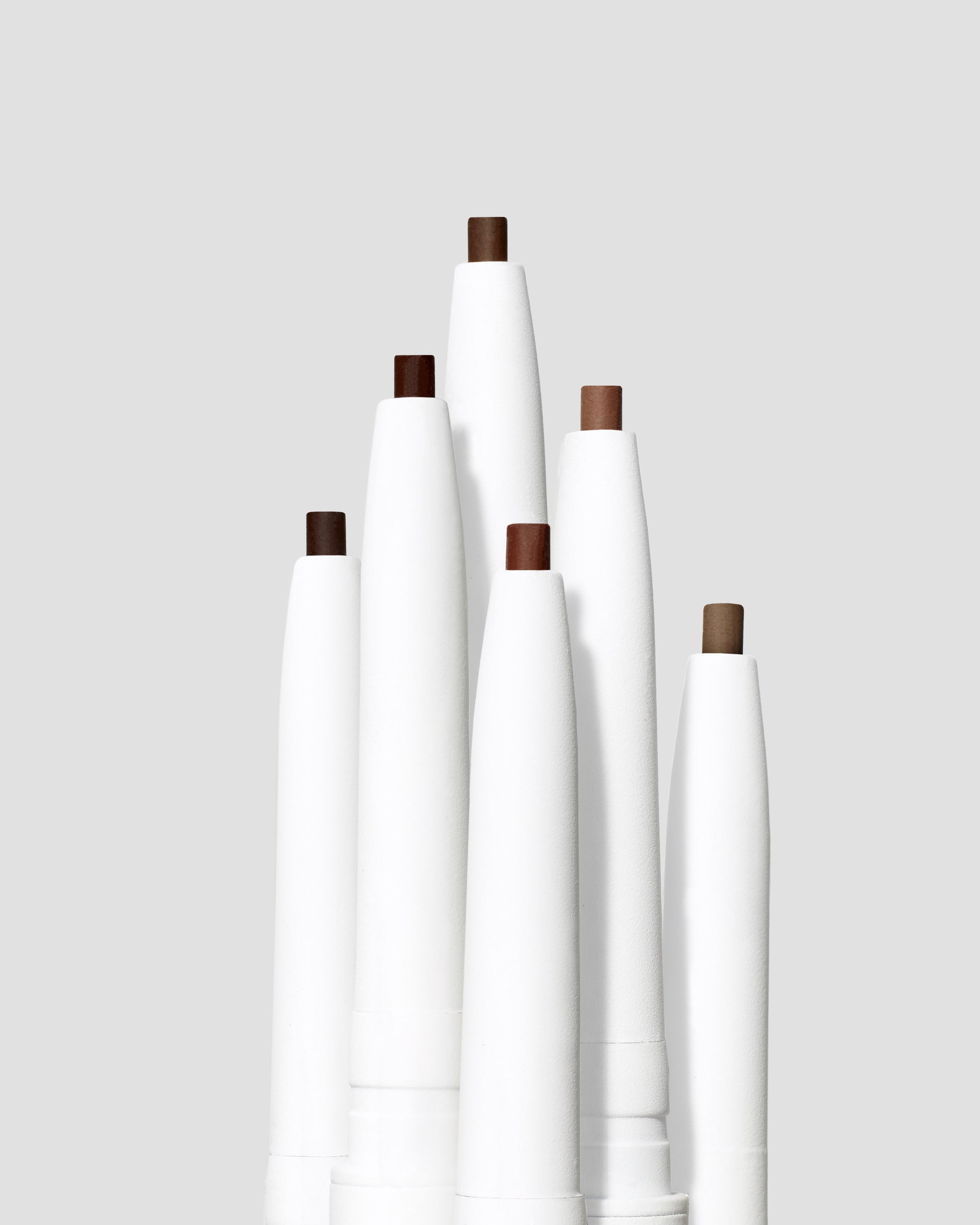 Six PureBrow® Precision Pencils with varying brown shades, showcasing their micro-tip design for natural, full-looking brows.