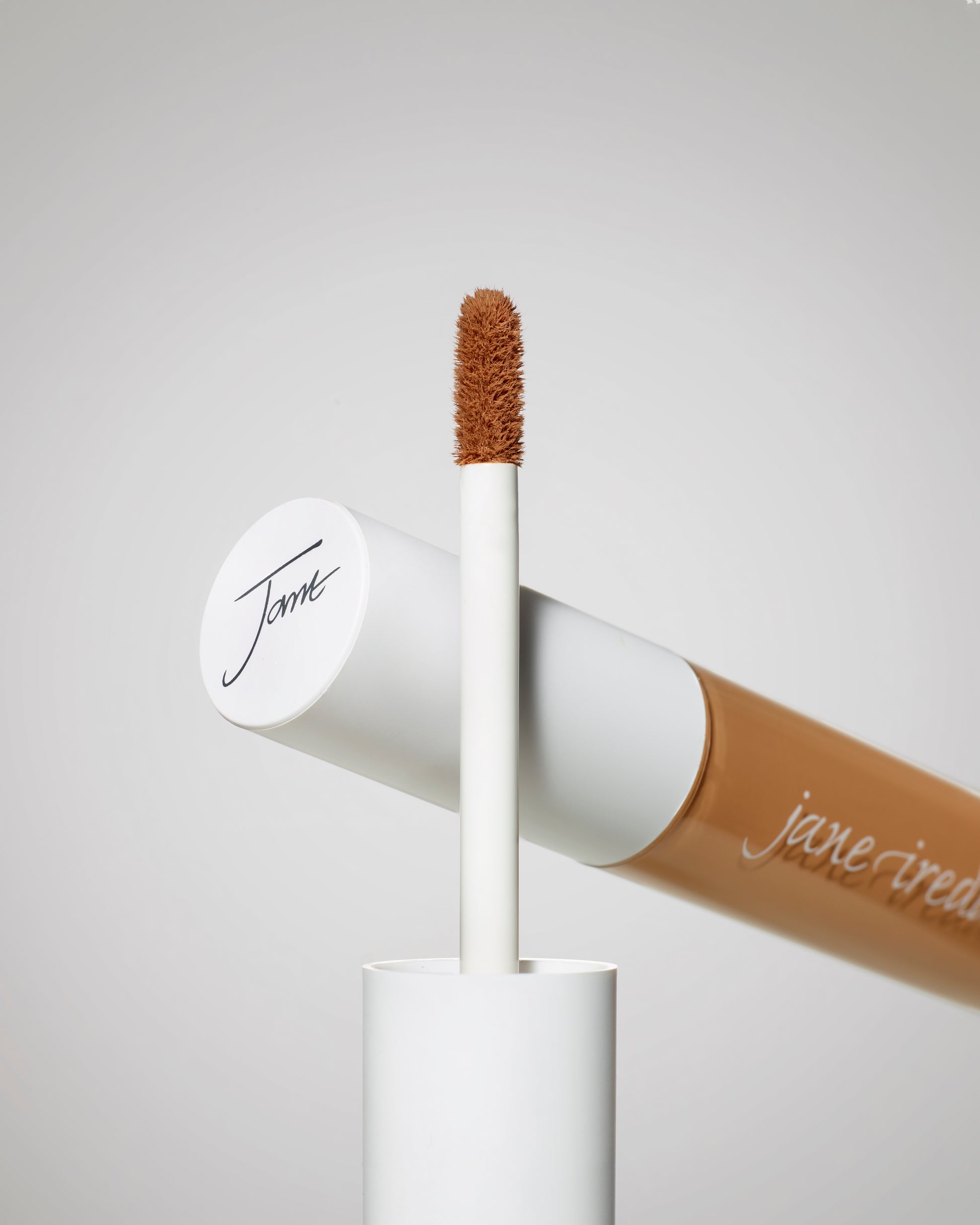 PureMatch™ Liquid Concealer tube with doe-foot applicator, featuring a warm beige-nude shade, branded “jane iredale,” ideal for seamless, buildable coverage.
