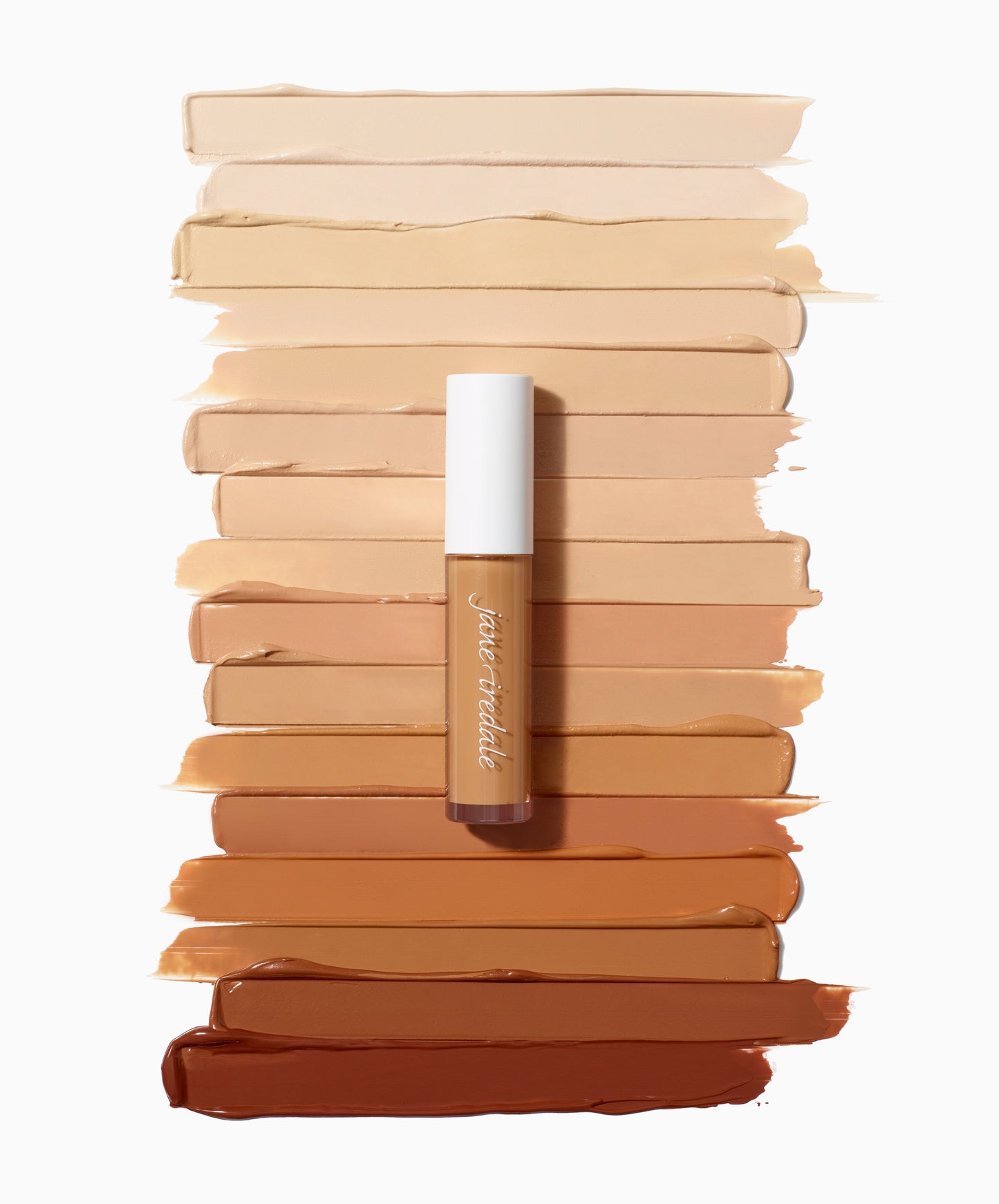 PureMatch™ Liquid Concealer tube atop diverse skin tone swatches, showcasing its inclusive 16-shade range and buildable, natural finish for seamless coverage.