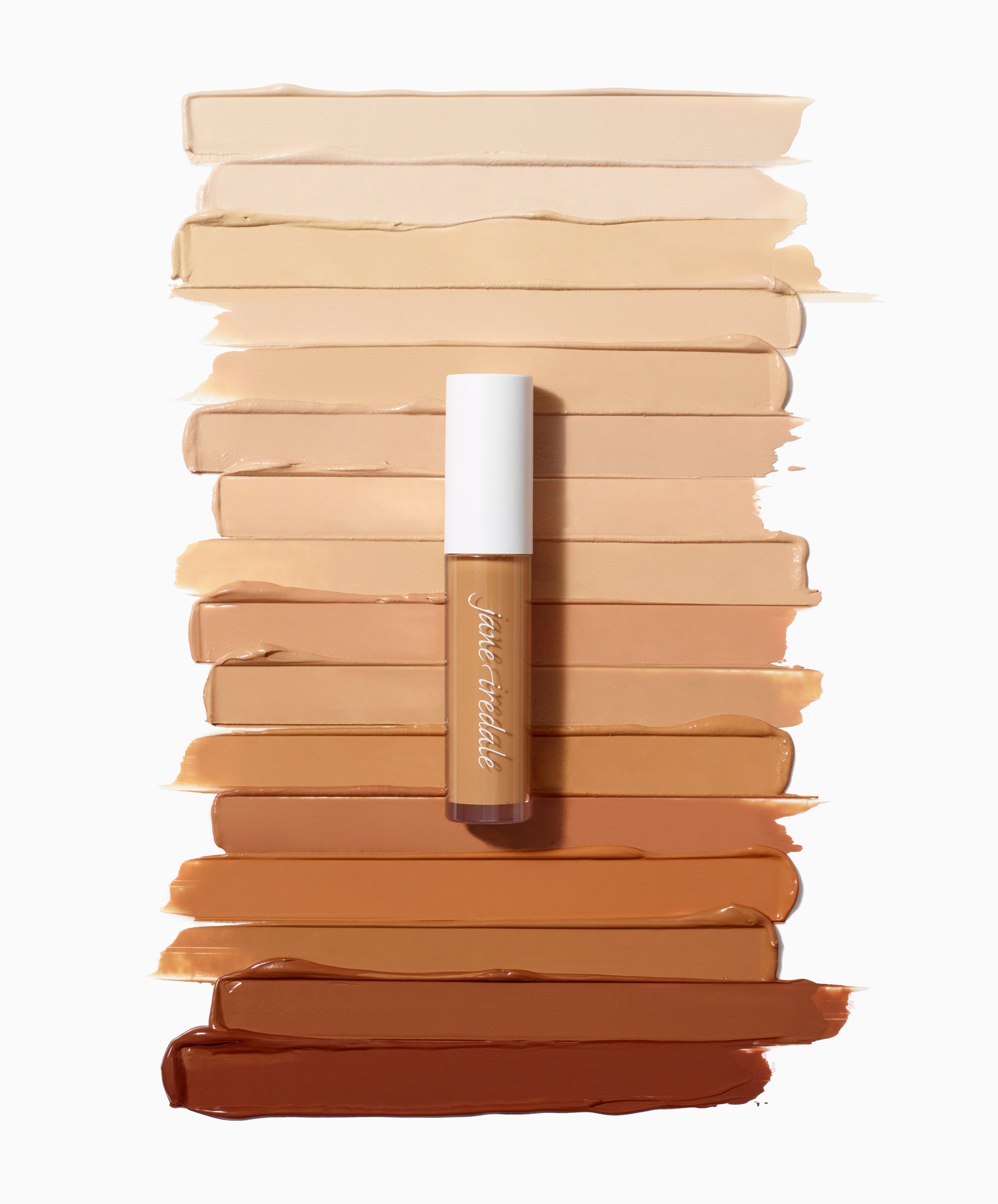 PureMatch™ Liquid Concealer tube atop diverse skin tone swatches, showcasing its inclusive 16-shade range and buildable, natural finish for seamless coverage.