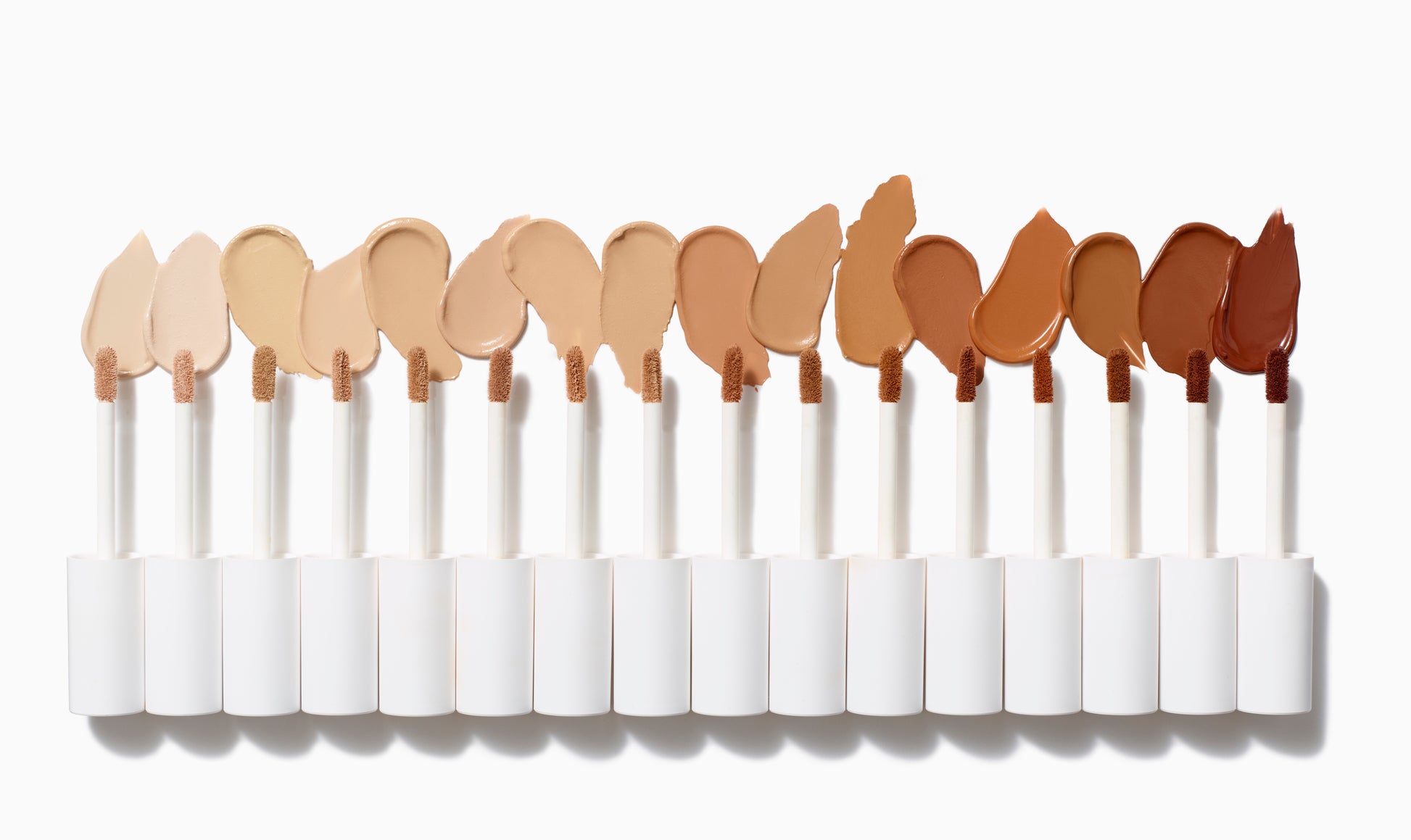 PureMatch™ Liquid Concealer wands in 18 shades from light to dark, showcasing inclusive coverage options with buildable, natural finish and precise doe-foot applicators.