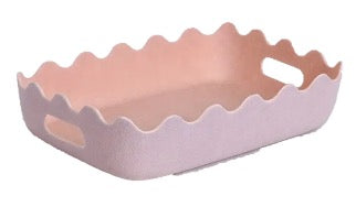 Pale pink tray with scalloped sides and handles, ideal for holding Beauty Shop Bellaire's Gift Basket filled with skincare and beauty products.