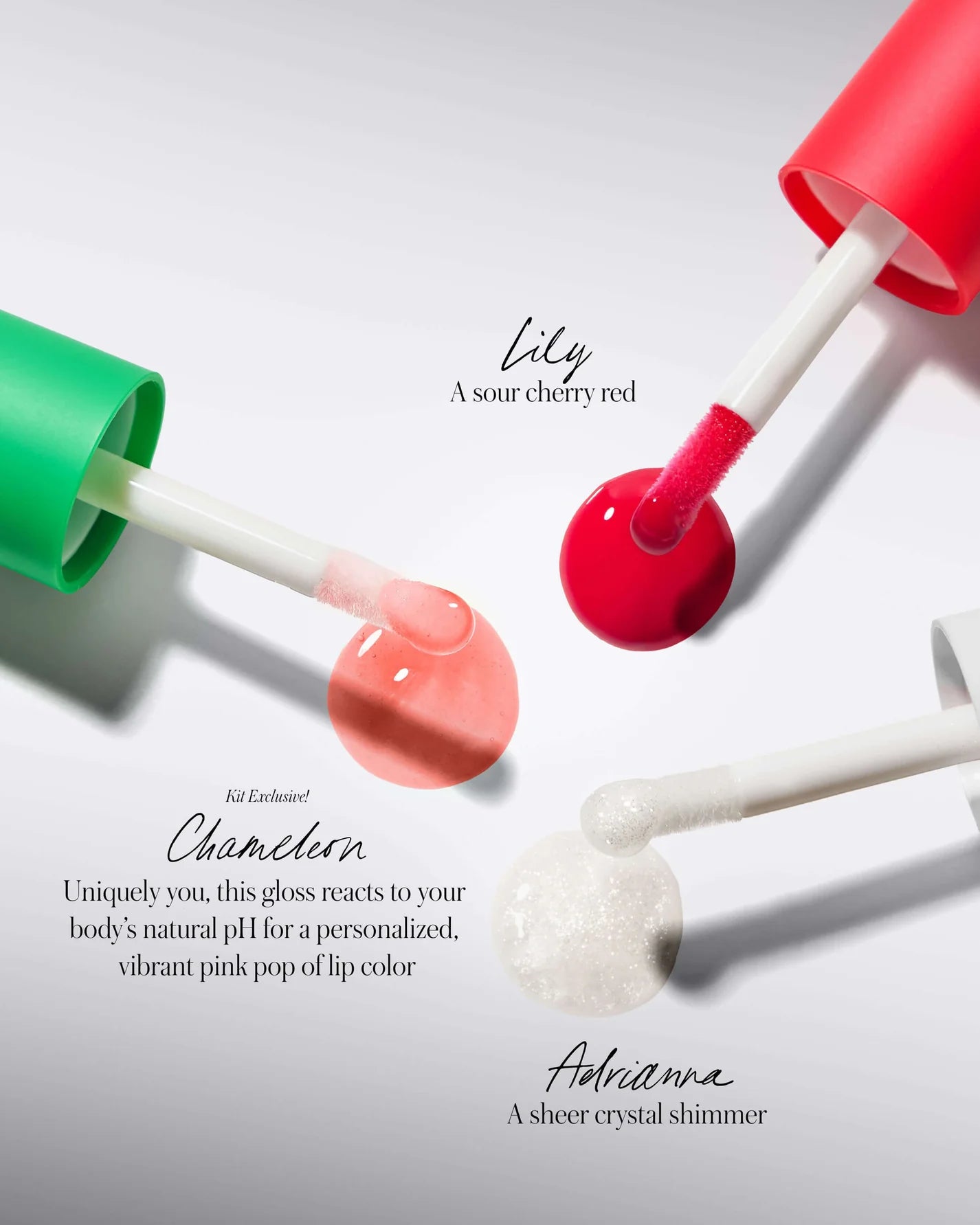 The Mini Lip Oil Trio with Lily, Chameleon, and Adrianna shades shown with applicators and color puddles, offering nourishing, high-shine finishes.