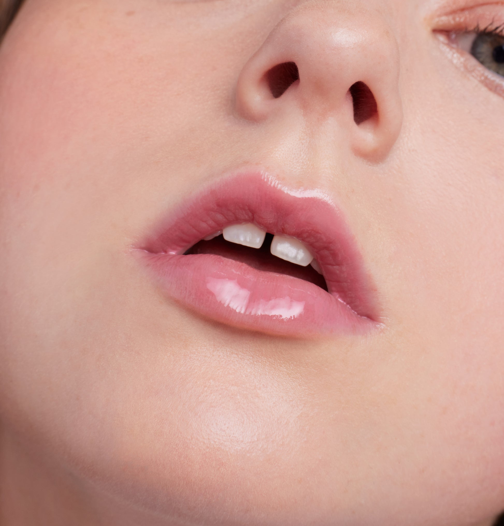 Close-up of glossy pink lips using ColorLuxe High Impact Lip Glaze, highlighting its bold color and shine, perfect for a statement lip look.