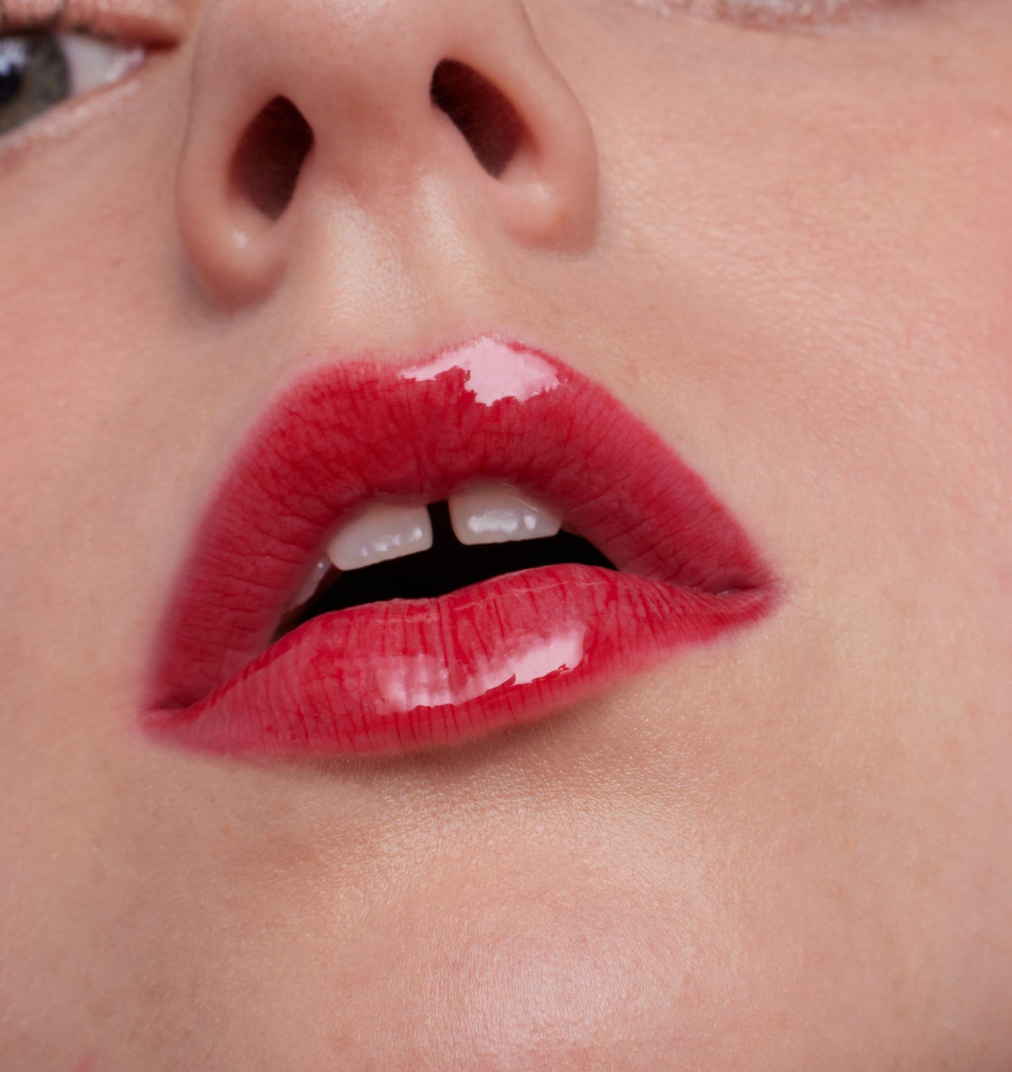 Close-up of lips wearing ColorLuxe High Impact Lip Glaze, showcasing its glossy, bold finish and high pigmentation for a standout, comfortable wear.