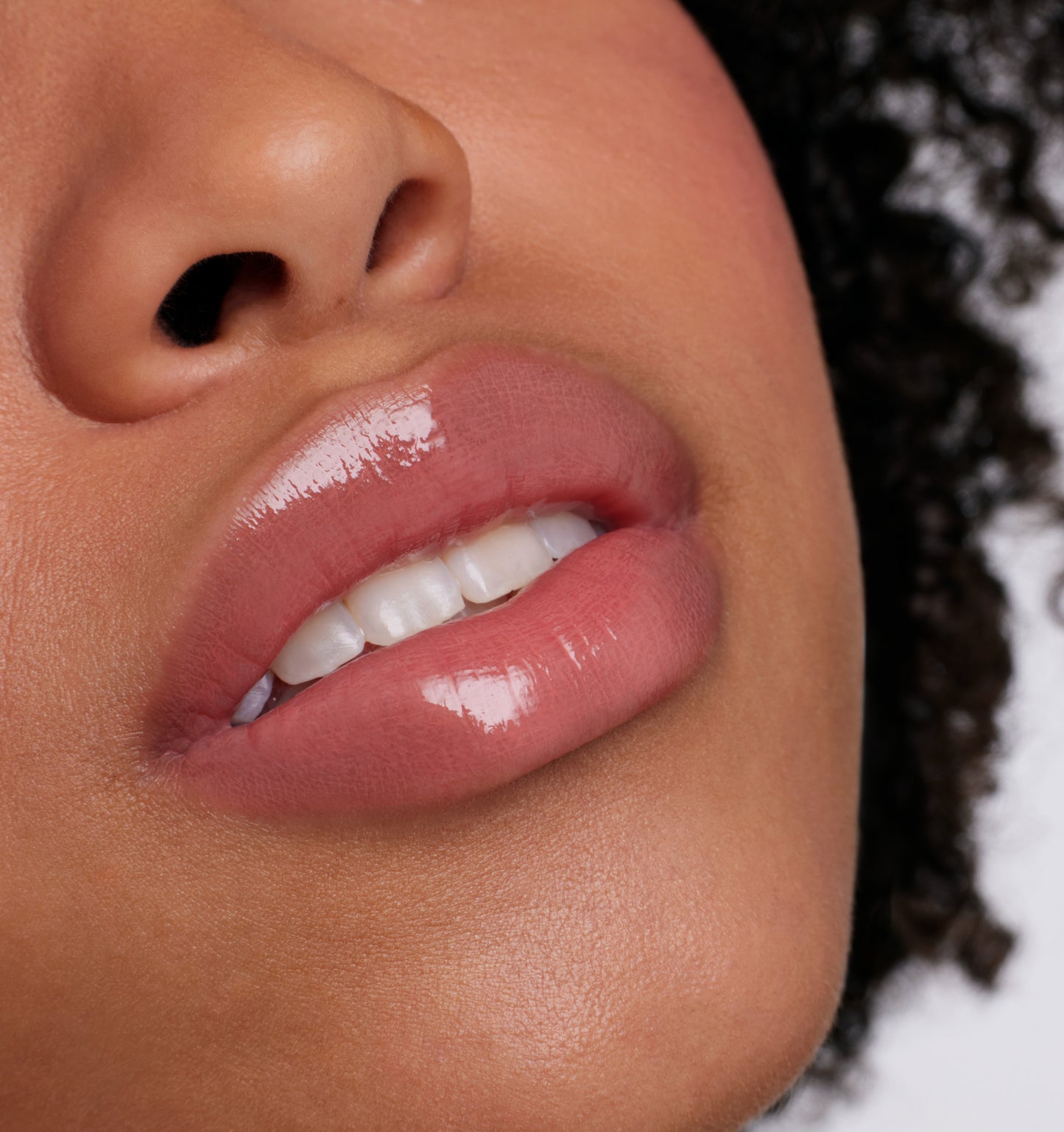 Close-up of glossy lips wearing ColorLuxe High Impact Lip Glaze, highlighting its bold color and shine, perfect for a statement look.