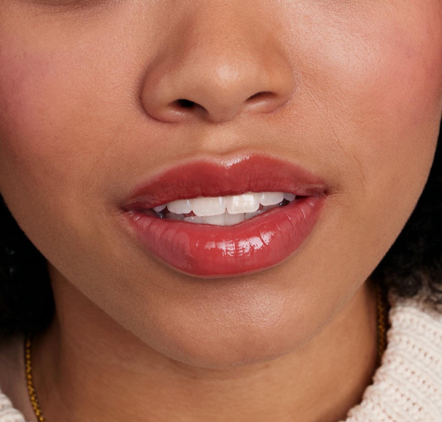 Close-up of glossy red lips showcasing ColorLuxe High Impact Lip Glaze, highlighting its bold, glossy finish and nourishing formula for a standout look.